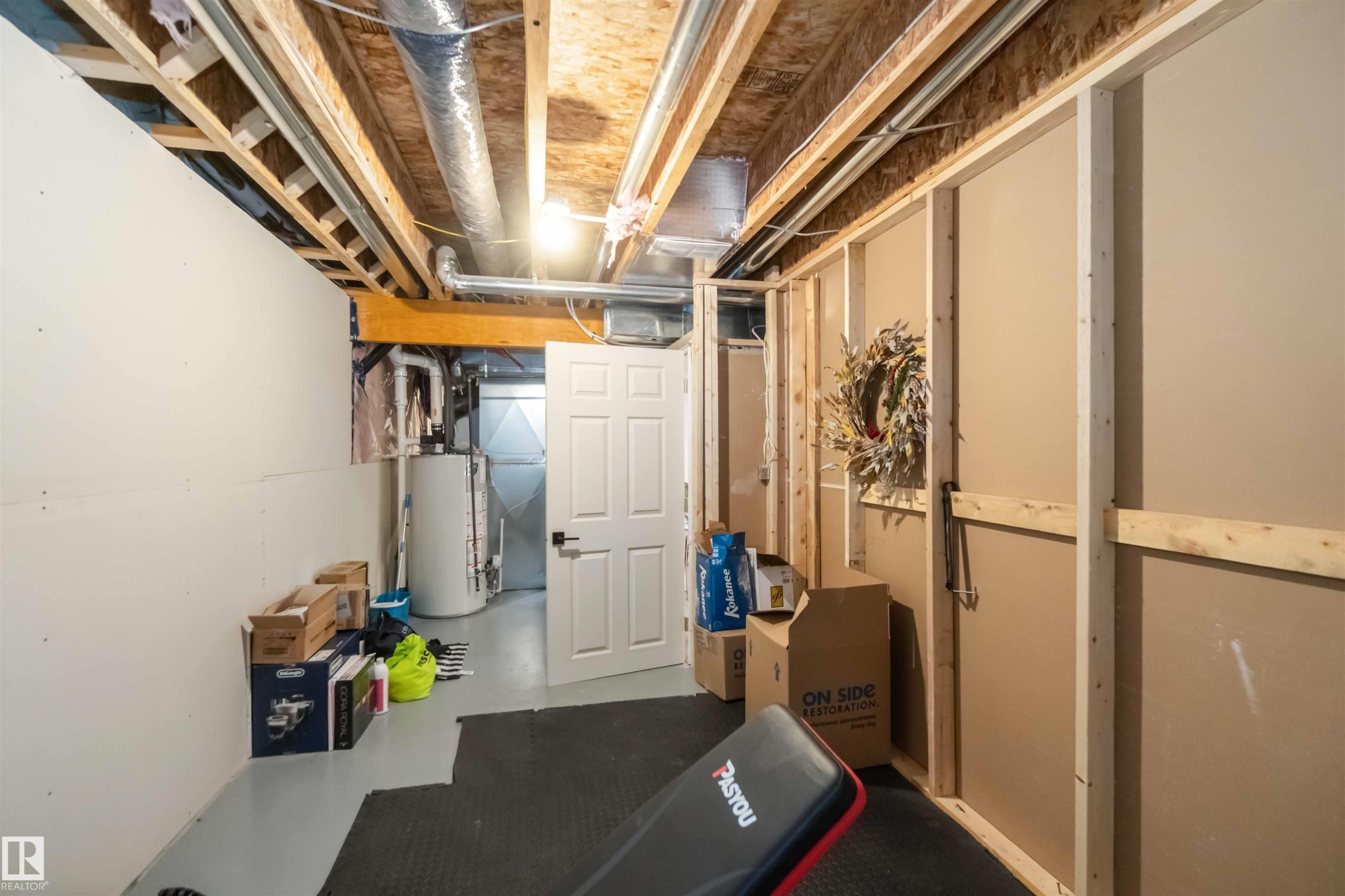 Unfinished basement featuring gas water heater - 17143 38 Street, Edmonton, AB - Indoor Photo Showing Basement