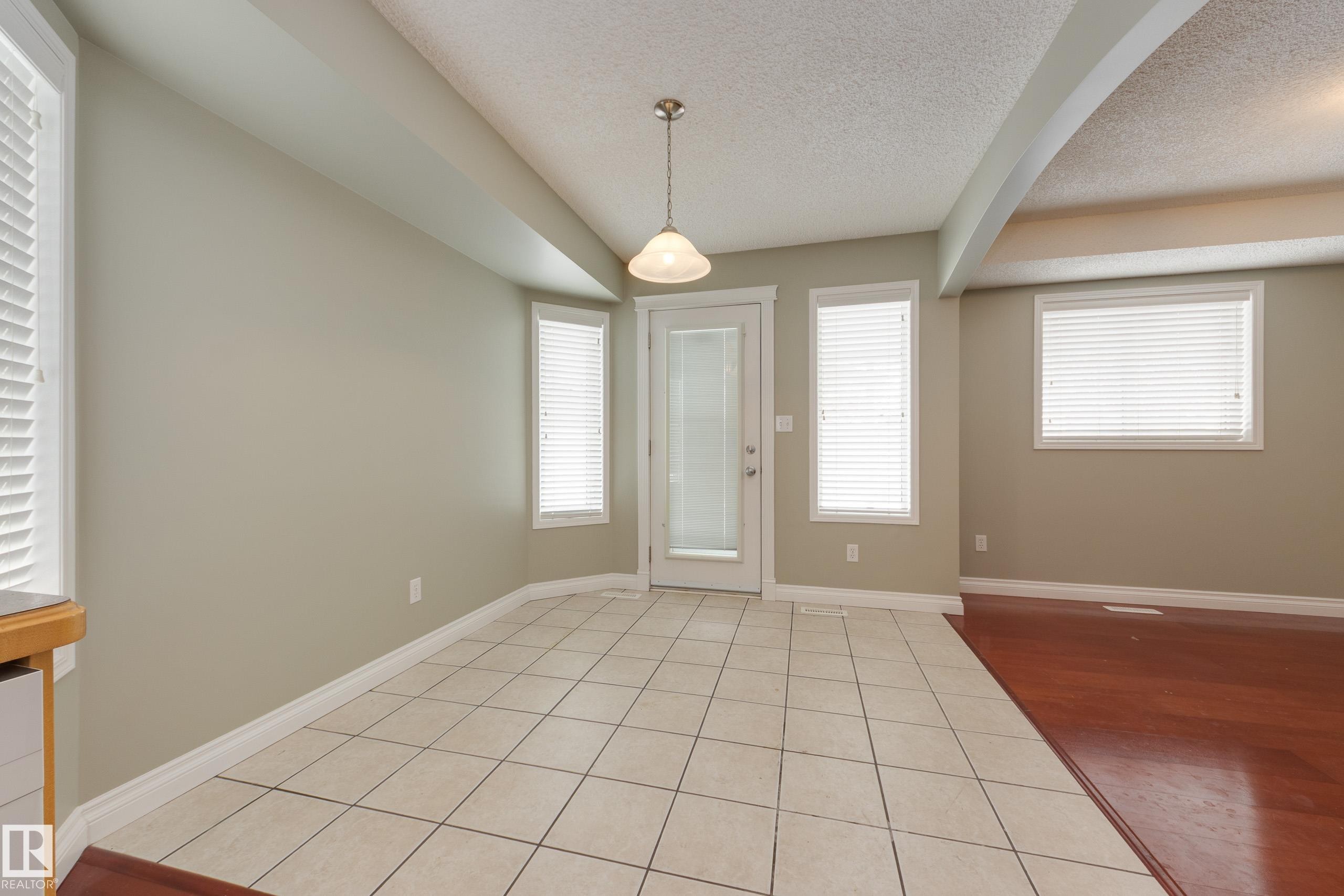 Entryway with light tile patterned floors and a textured ceiling - 9916 178 Avenue, Edmonton, AB - Indoor Photo Showing Other Room