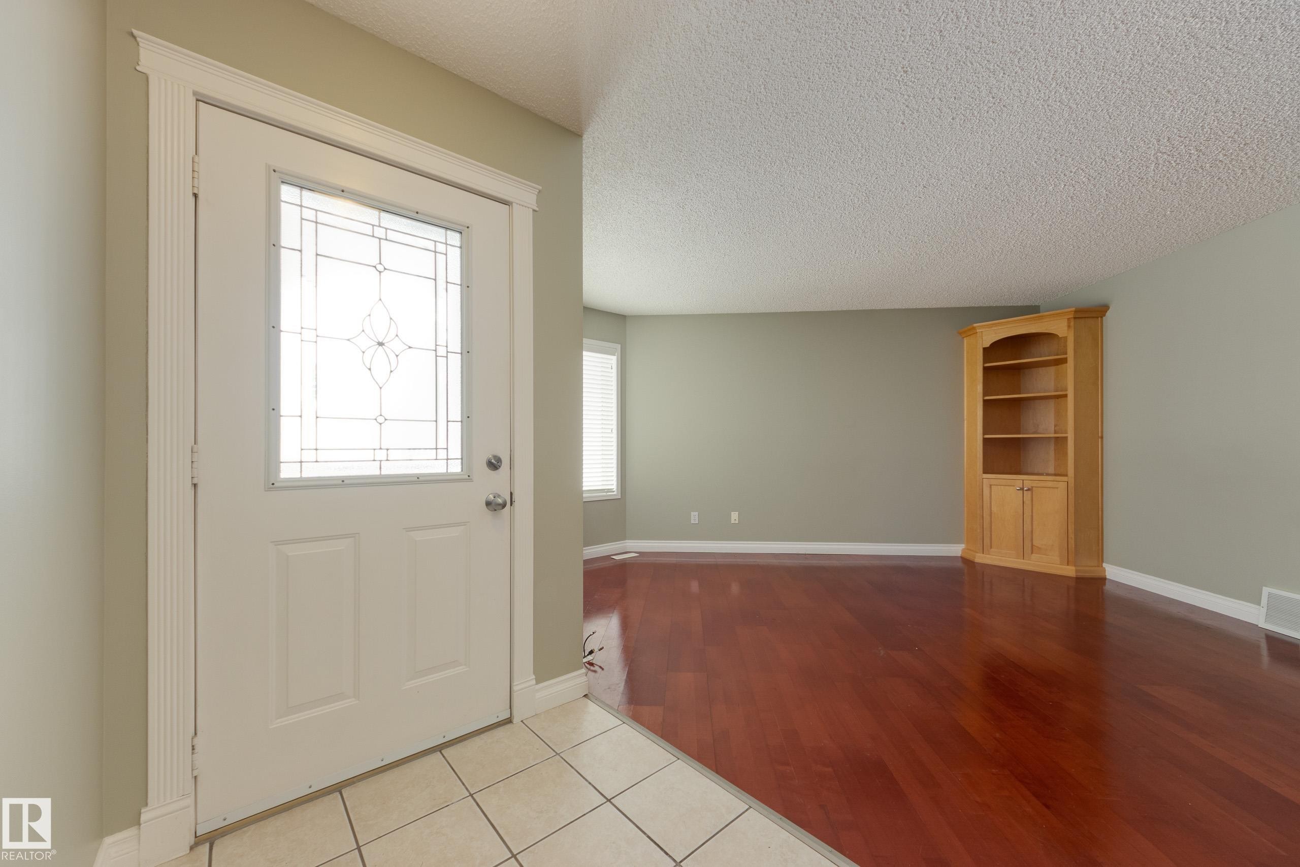 Entrance foyer featuring light tile patterned flooring and a textured ceiling - 9916 178 Avenue, Edmonton, AB - Indoor Photo Showing Other Room