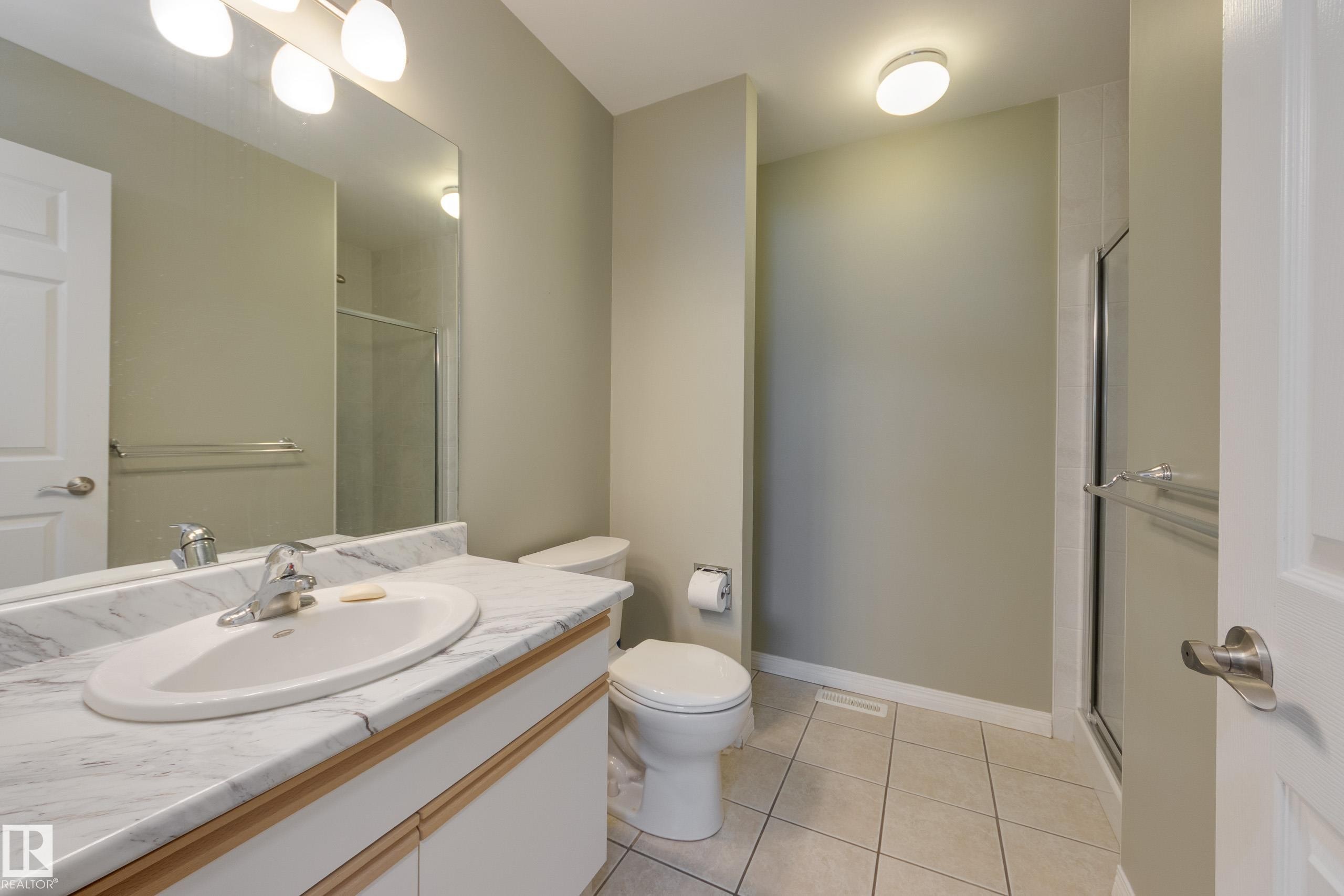 Full bathroom featuring vanity, a shower stall, and light tile patterned floors - 9916 178 Avenue, Edmonton, AB - Indoor Photo Showing Bathroom
