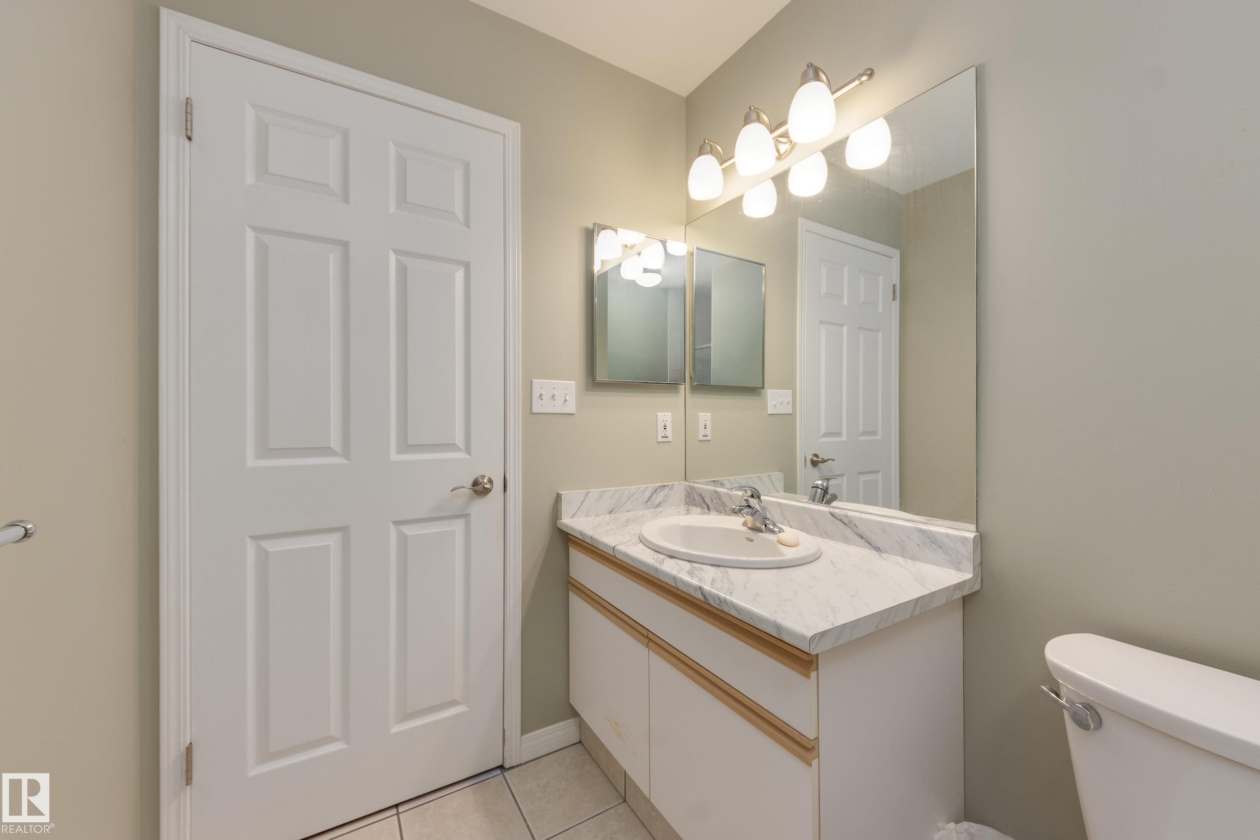 Bathroom with vanity and light tile patterned floors - 9916 178 Avenue, Edmonton, AB - Indoor Photo Showing Bathroom