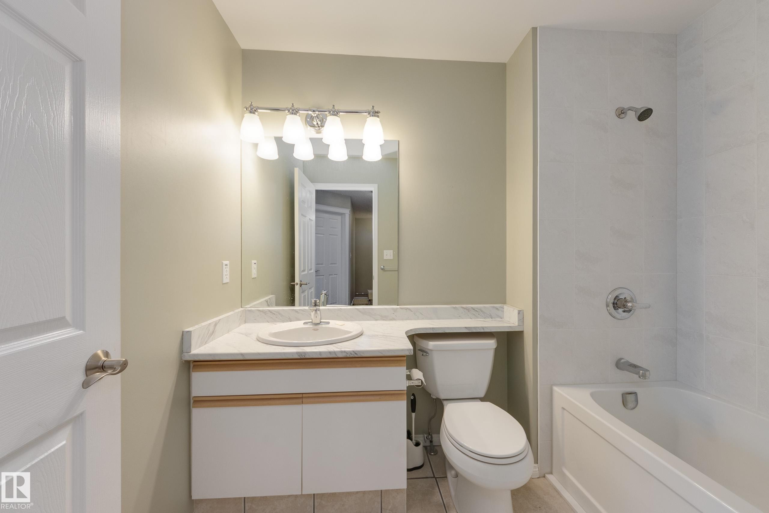 Bathroom featuring vanity, shower / tub combination, and light tile patterned floors - 9916 178 Avenue, Edmonton, AB - Indoor Photo Showing Bathroom