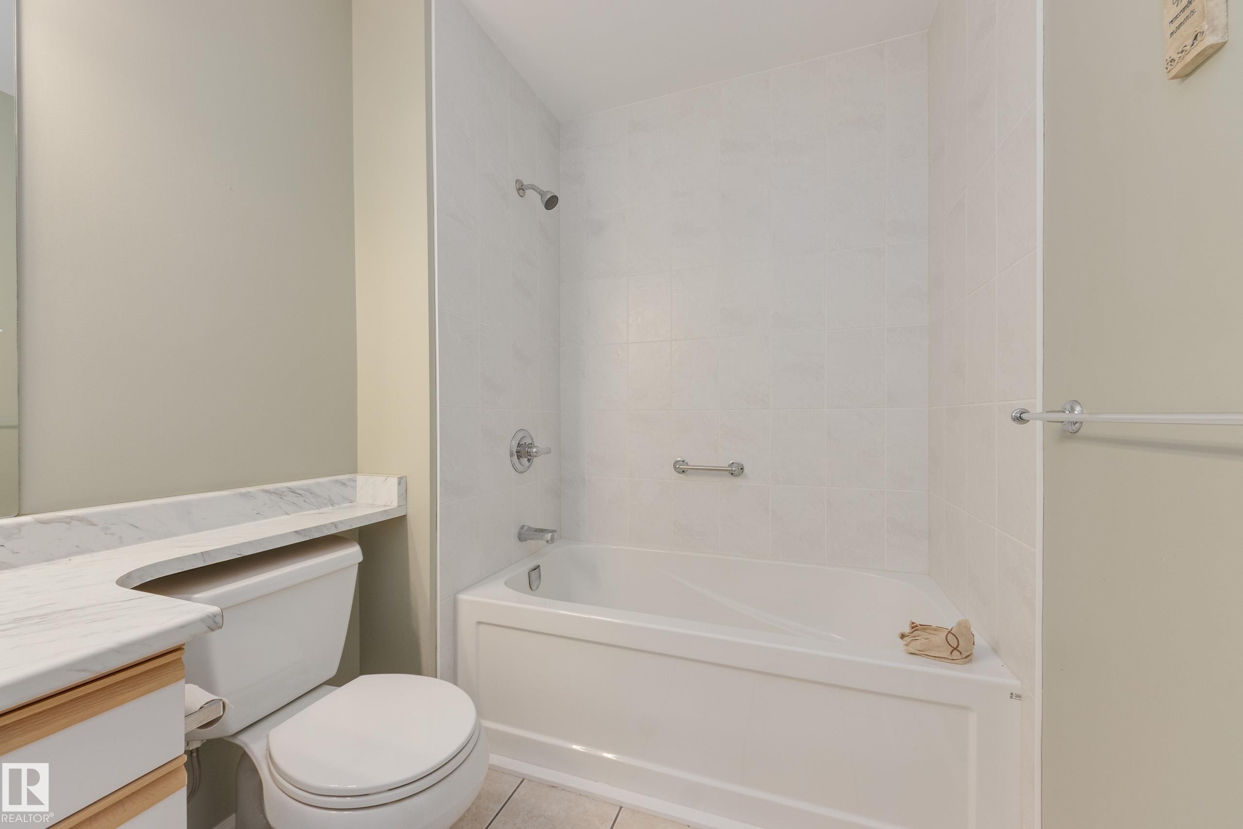Full bath with vanity, bathtub / shower combination, and light tile patterned floors - 9916 178 Avenue, Edmonton, AB - Indoor Photo Showing Bathroom