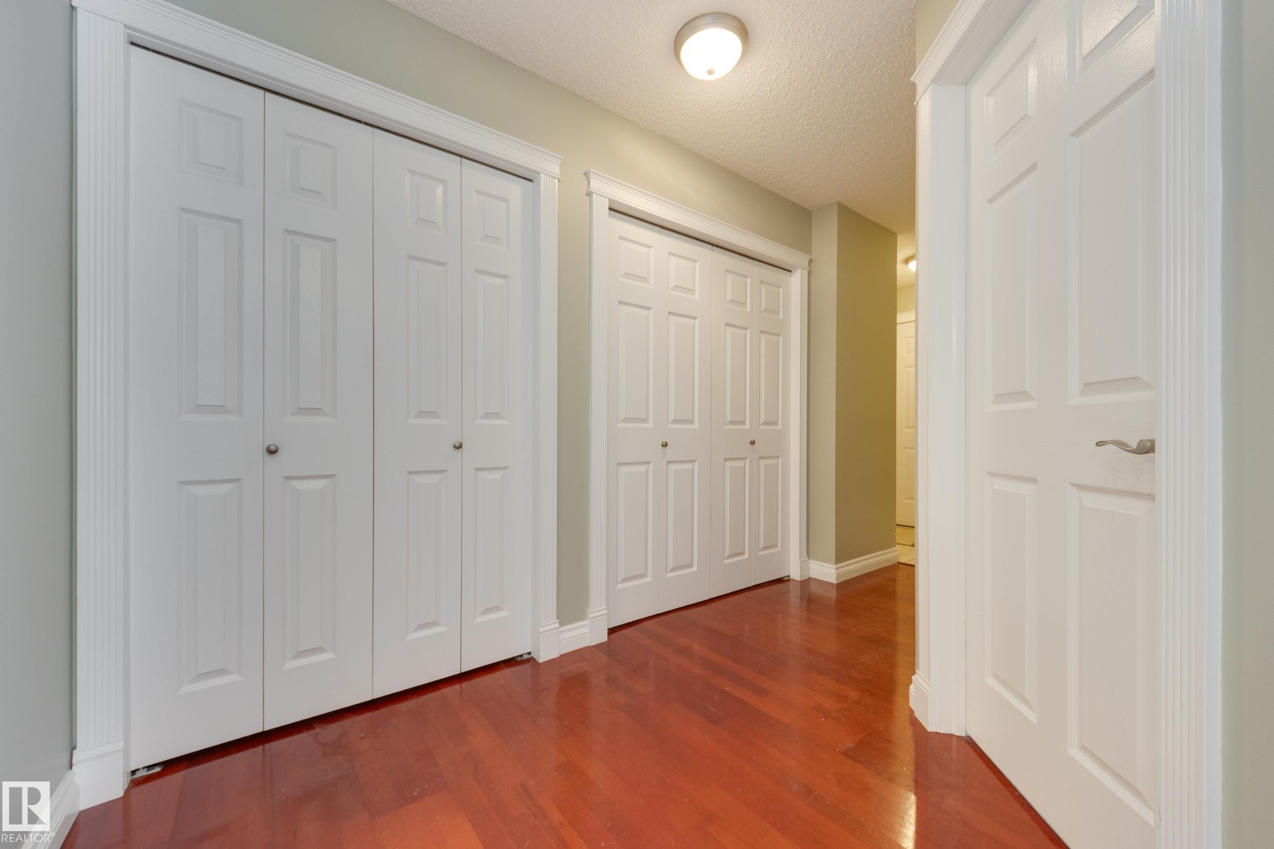 Hallway featuring dark wood finished floors and a textured ceiling - 9916 178 Avenue, Edmonton, AB - Indoor Photo Showing Other Room