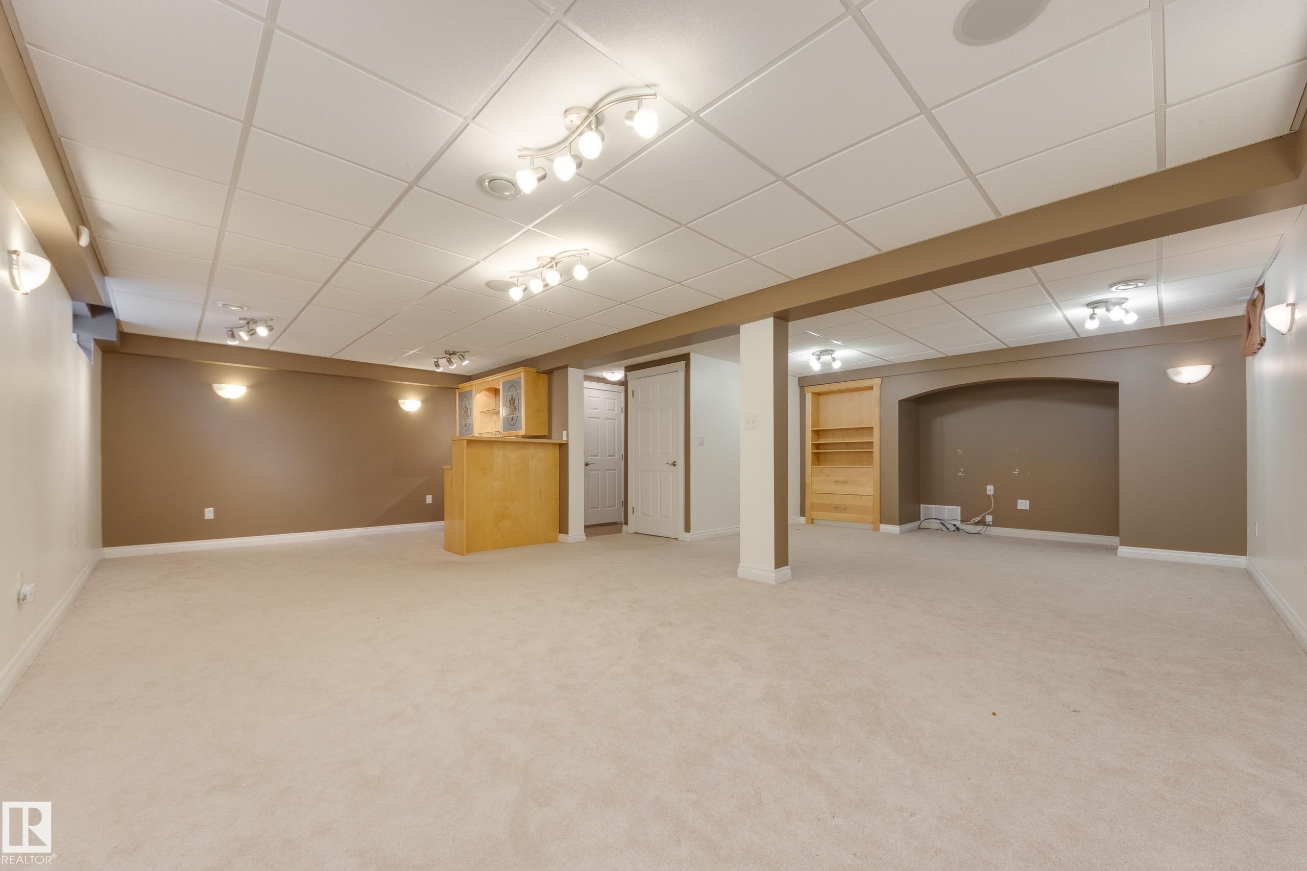 Finished below grade area with light carpet and a paneled ceiling - 9916 178 Avenue, Edmonton, AB - Indoor