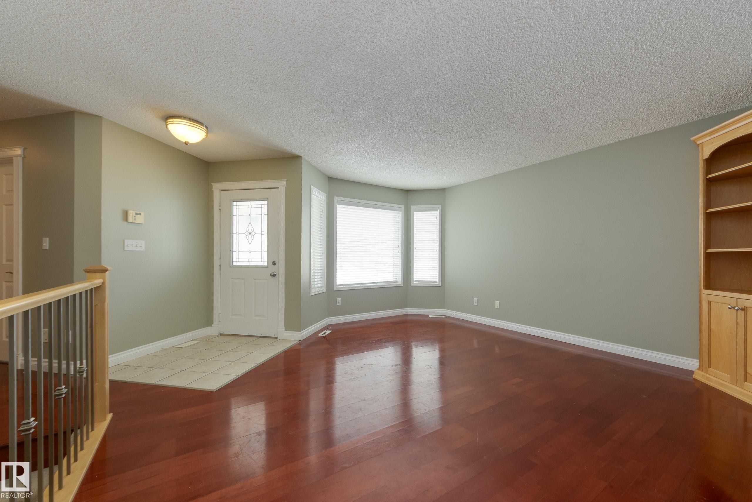 Foyer featuring a textured ceiling and dark wood-type flooring - 9916 178 Avenue, Edmonton, AB - Indoor Photo Showing Other Room
