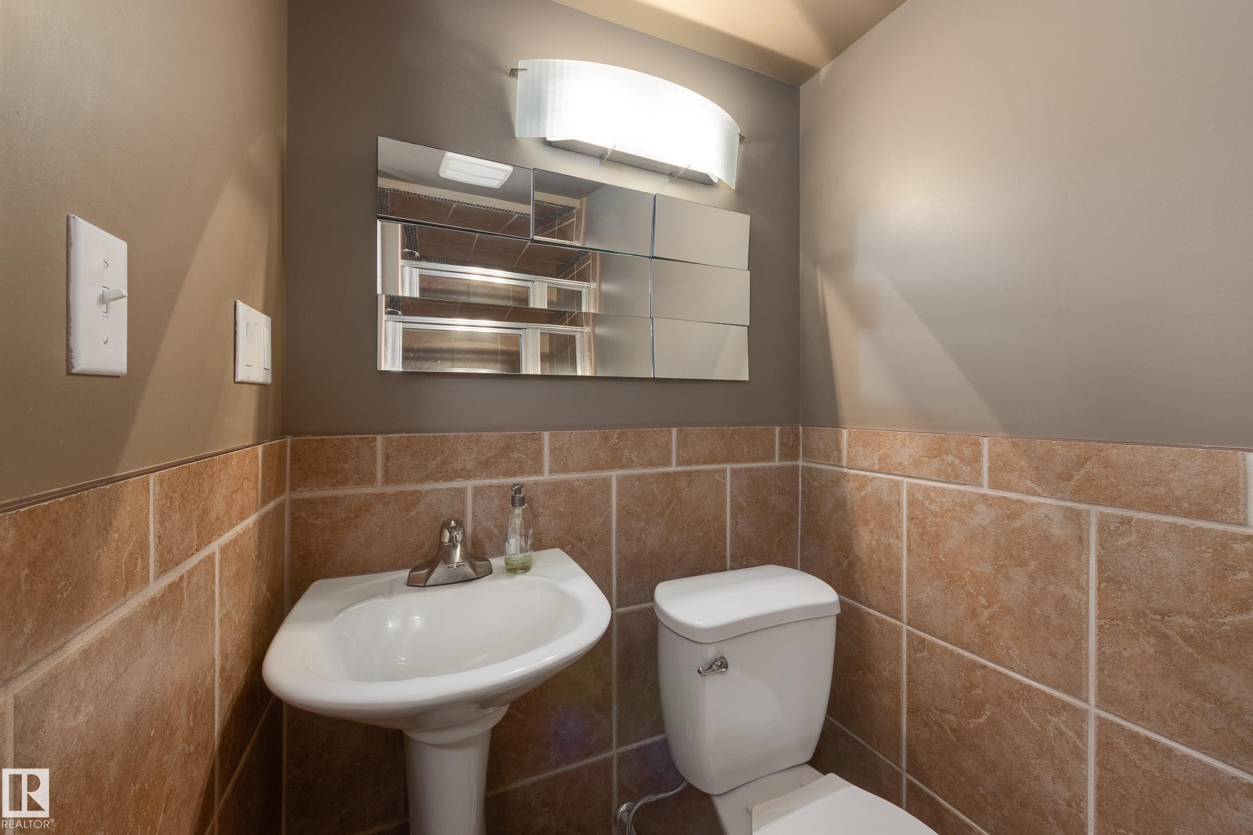 Bathroom featuring wainscoting and tile walls - 9916 178 Avenue, Edmonton, AB - Indoor Photo Showing Bathroom
