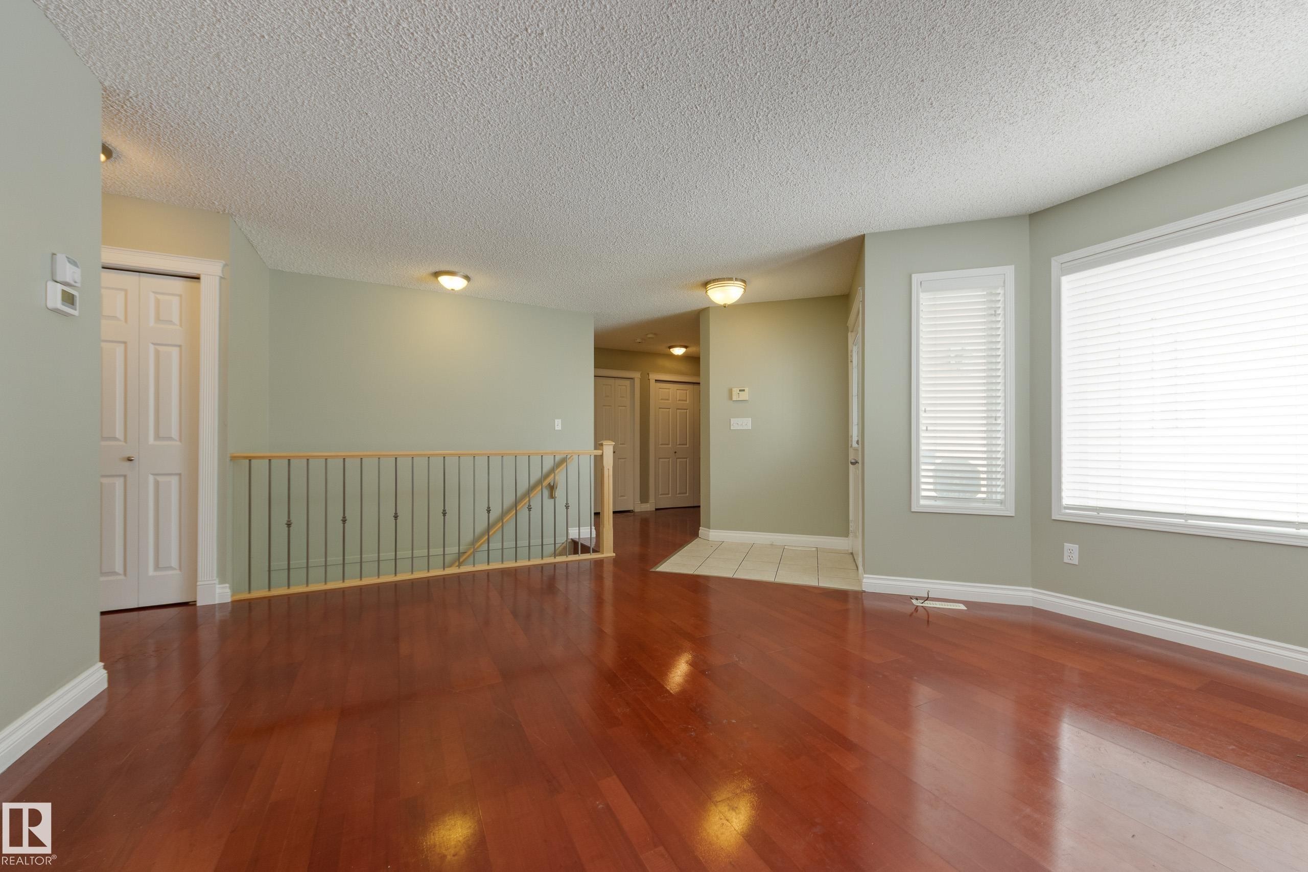 Unfurnished room with wood finished floors and a textured ceiling - 9916 178 Avenue, Edmonton, AB - Indoor Photo Showing Other Room