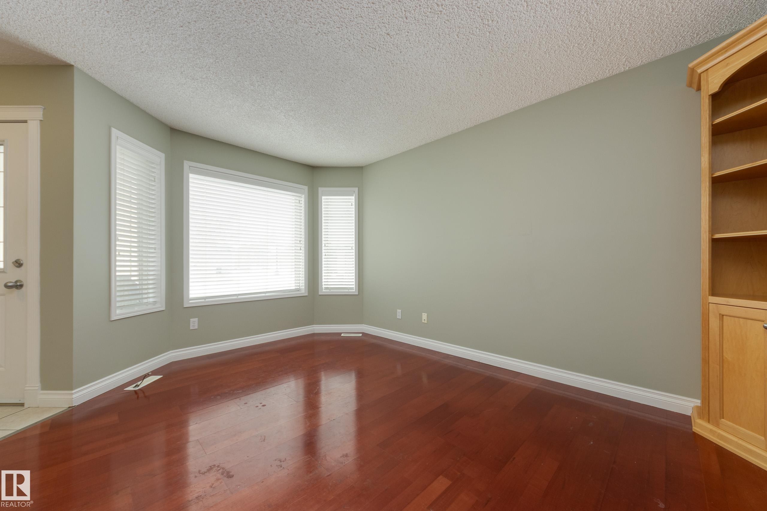 Unfurnished room with dark wood finished floors and a textured ceiling - 9916 178 Avenue, Edmonton, AB - Indoor Photo Showing Other Room