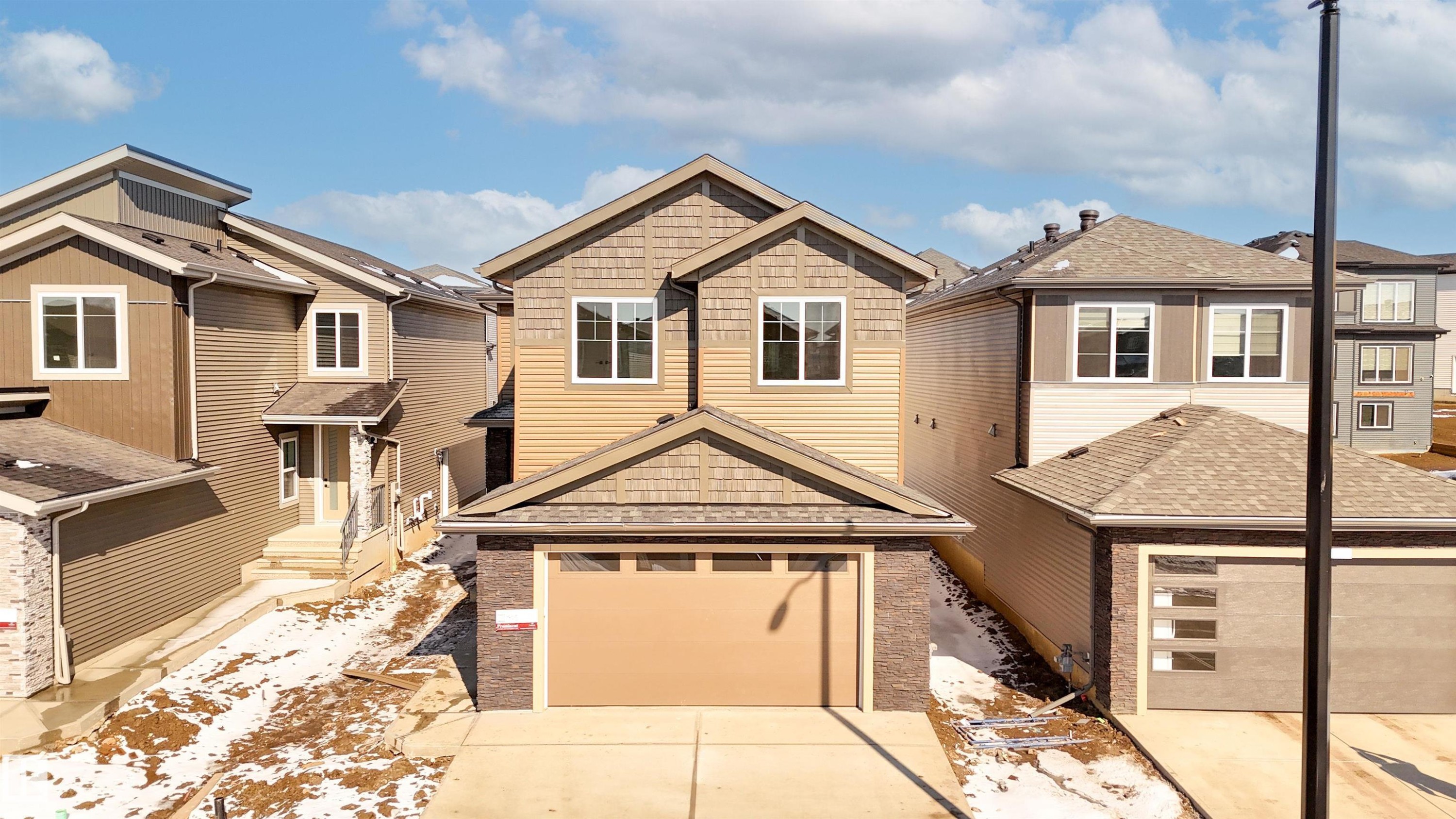 Craftsman house with concrete driveway, a residential view, a shingled roof, and an attached garage - 3910 41 Avenue, Beaumont, AB - Outdoor