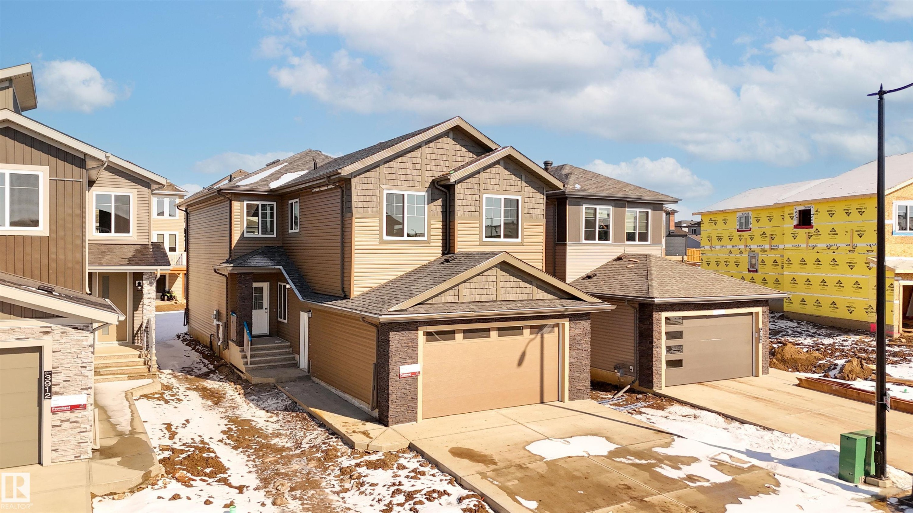 Craftsman inspired home featuring roof with shingles, a residential view, concrete driveway, and a garage - 3910 41 Avenue, Beaumont, AB - Outdoor