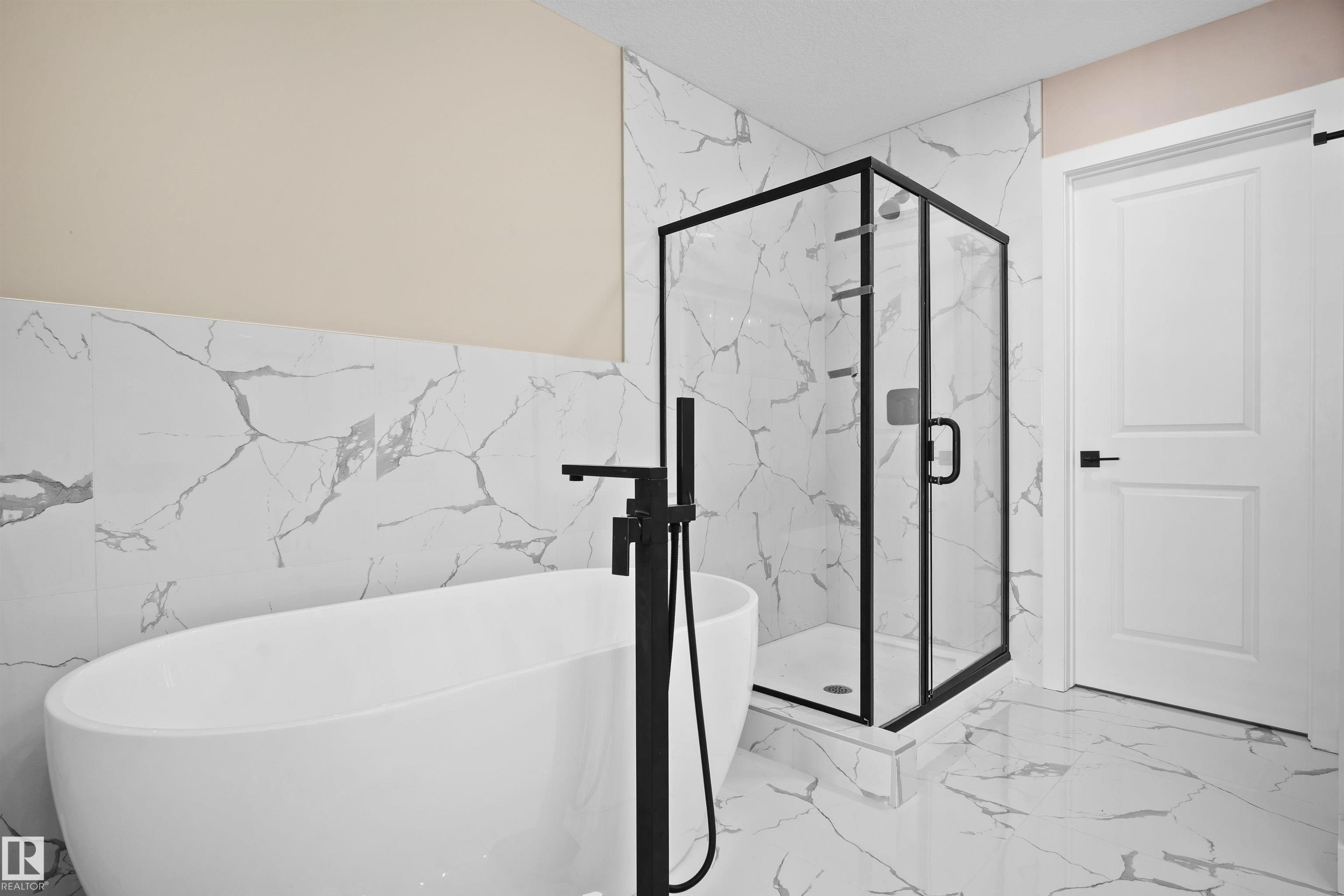 Bathroom featuring light marble finish flooring, a marble finish shower, a soaking tub, and tile walls - 3910 41 Avenue, Beaumont, AB - Indoor Photo Showing Other Room