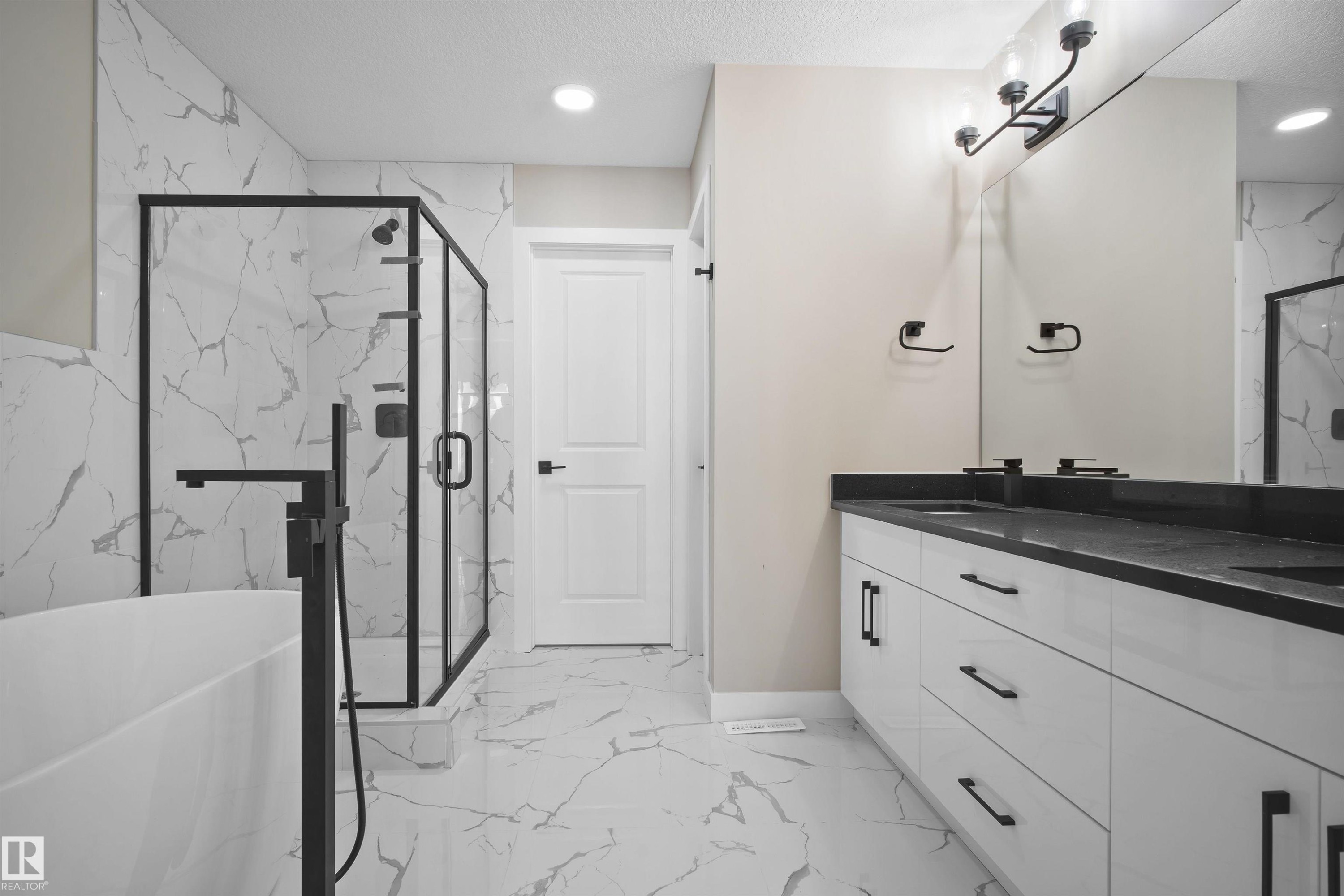 Bathroom with a marble finish shower, light marble finish floors, double vanity, a soaking tub, and a textured ceiling - 3910 41 Avenue, Beaumont, AB - Indoor Photo Showing Bathroom