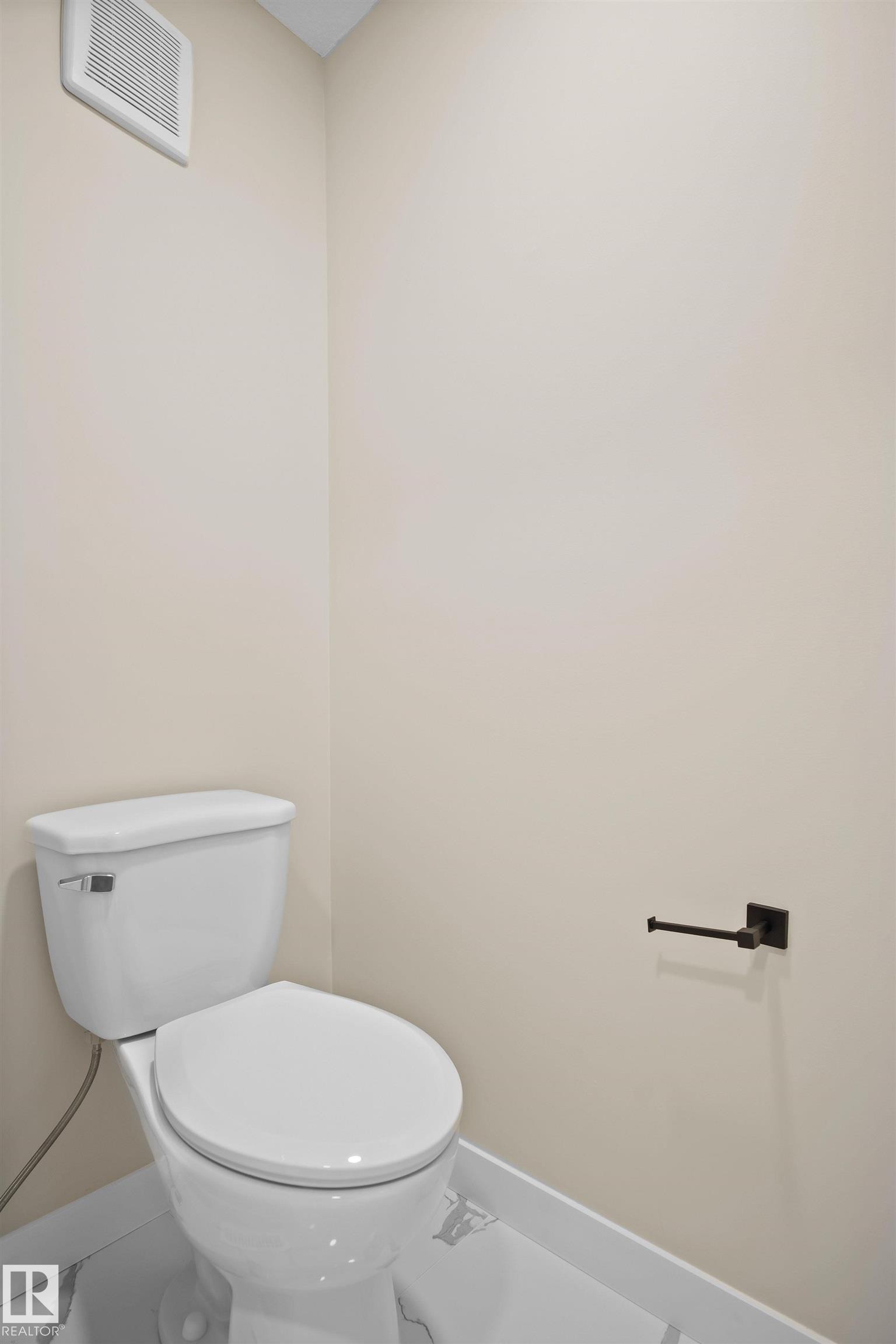 Bathroom featuring toilet and baseboards - 3910 41 Avenue, Beaumont, AB - Indoor Photo Showing Bathroom