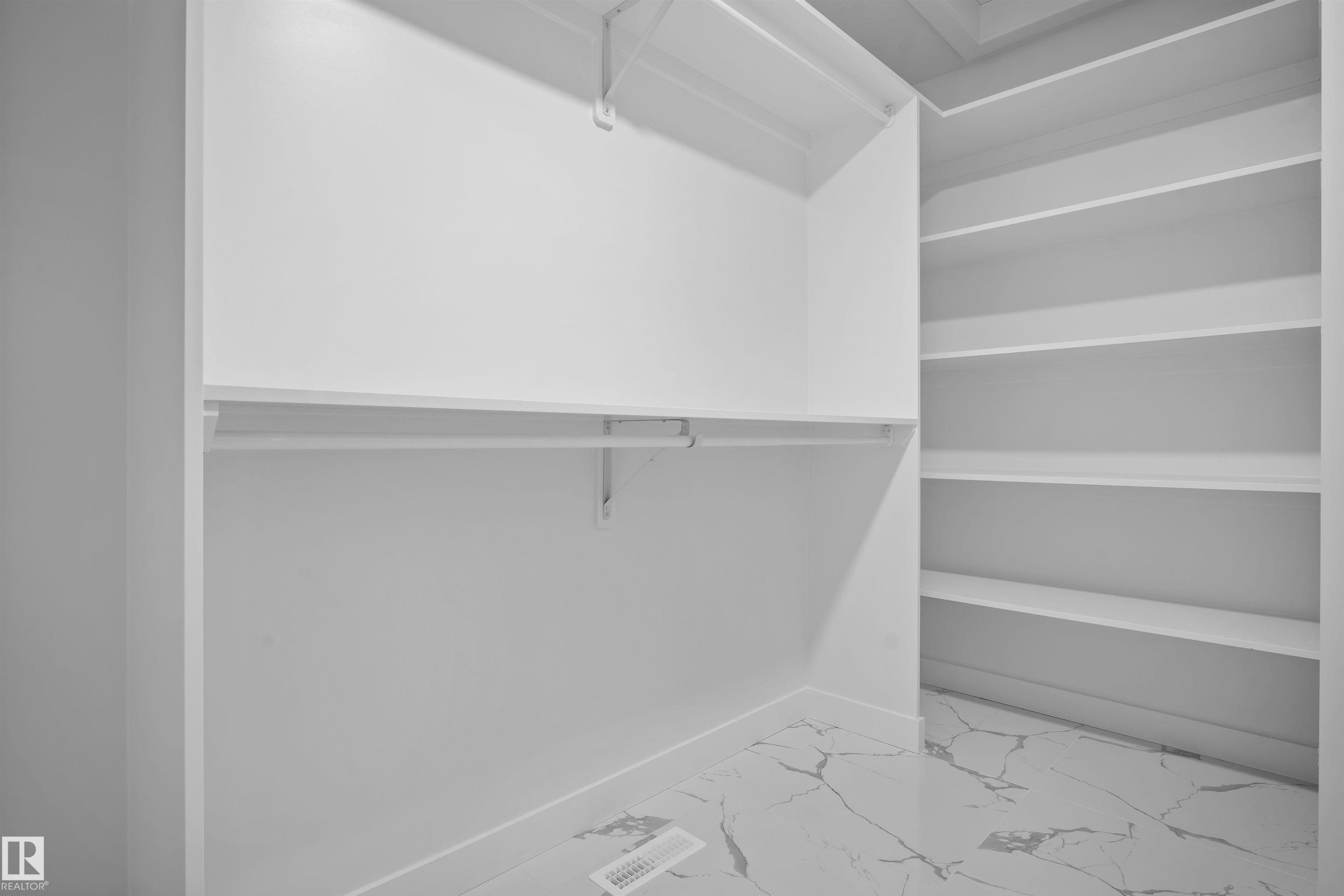 Walk in closet with light marble finish floors - 3910 41 Avenue, Beaumont, AB - Indoor With Storage