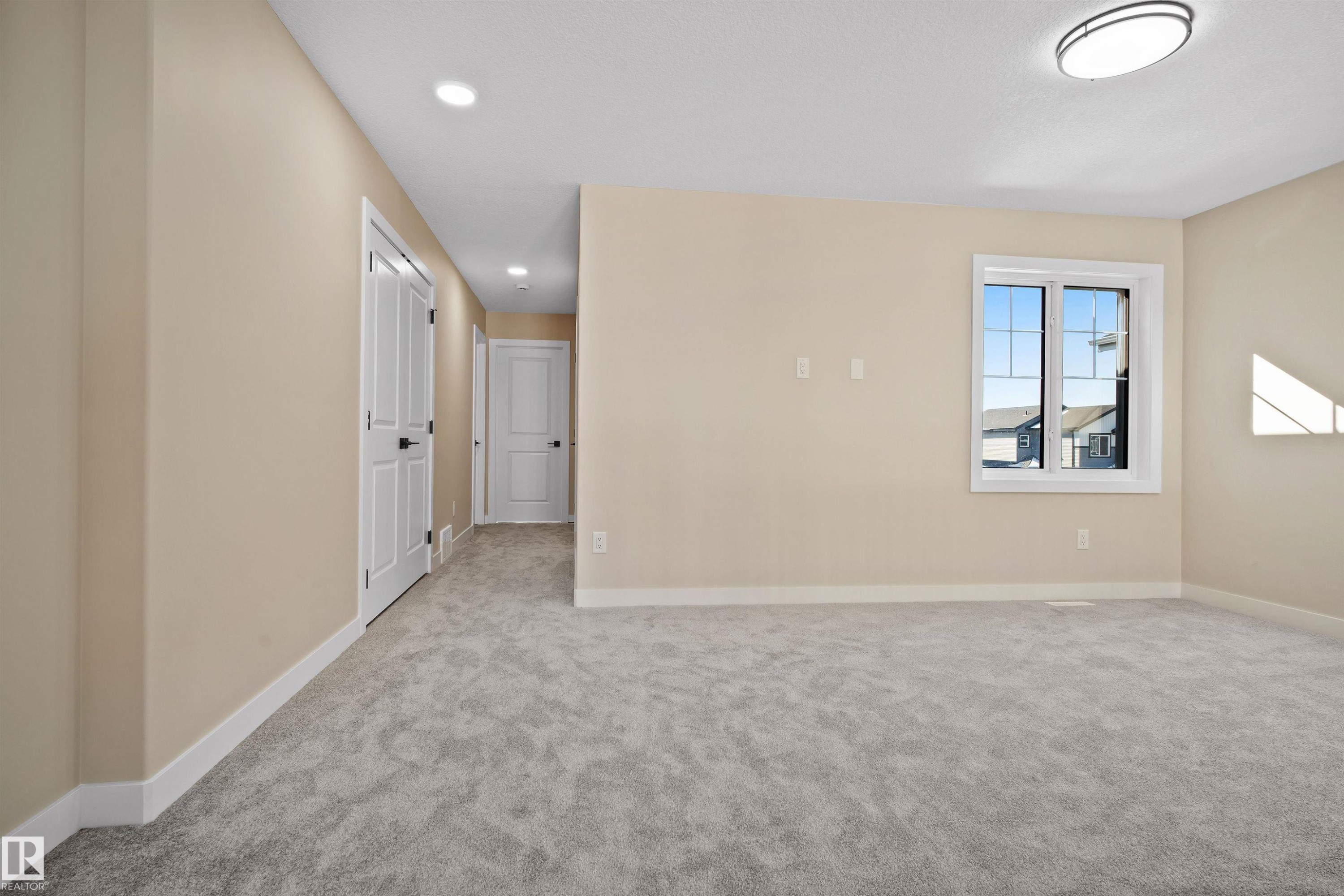 Empty room featuring light colored carpet and recessed lighting - 3910 41 Avenue, Beaumont, AB - Indoor Photo Showing Other Room