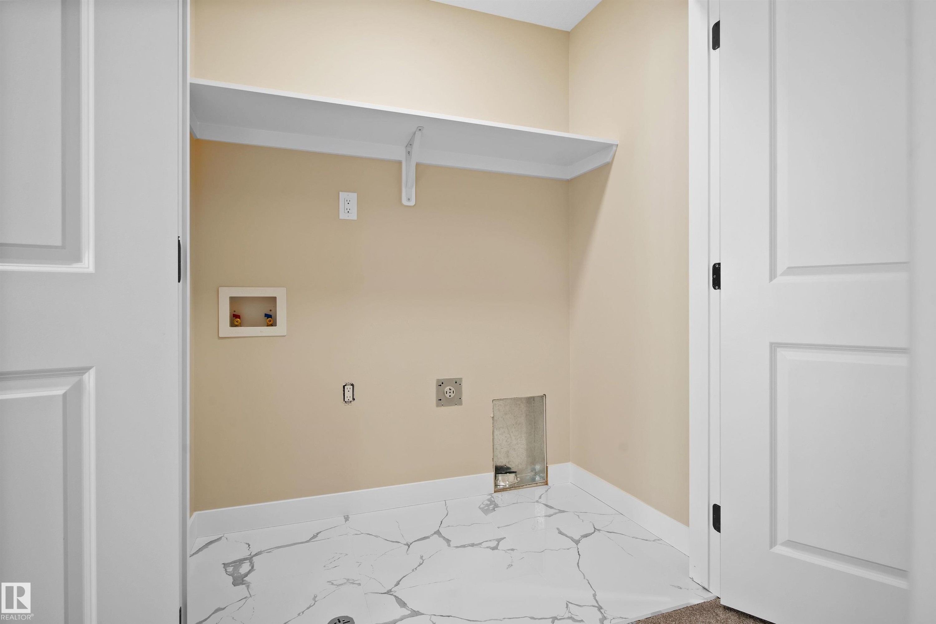 Laundry area with hookup for a washing machine and marble finish flooring - 3910 41 Avenue, Beaumont, AB - Indoor Photo Showing Other Room