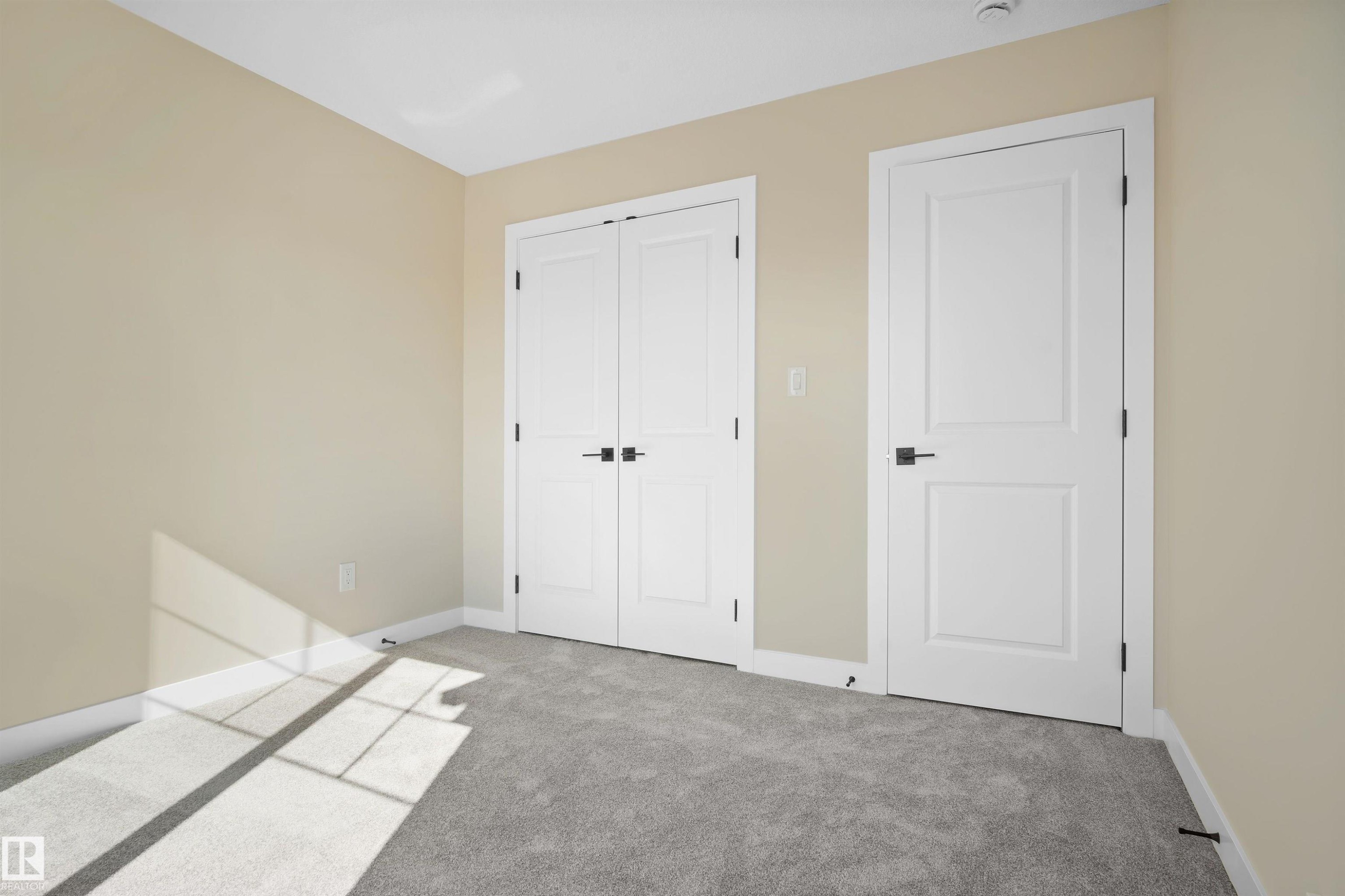 Unfurnished bedroom with light carpet and a closet - 3910 41 Avenue, Beaumont, AB - Indoor Photo Showing Other Room