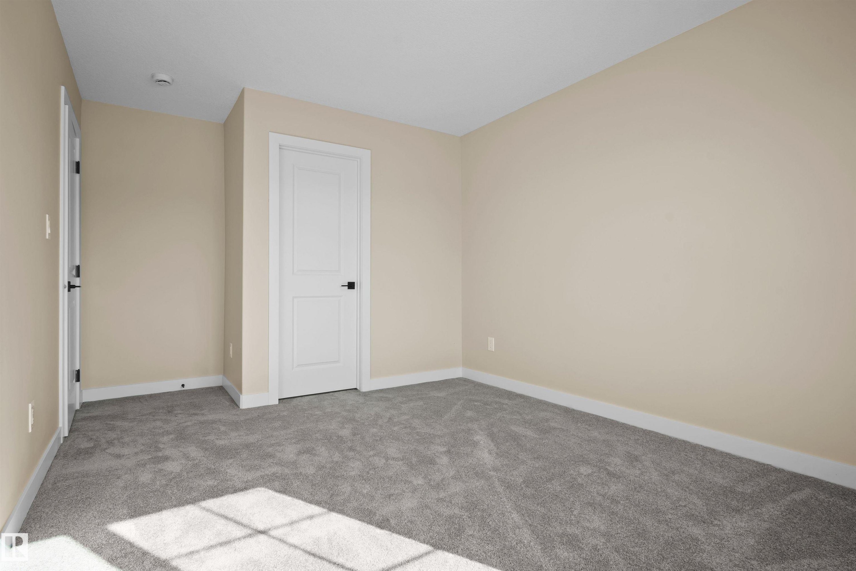Unfurnished bedroom with light colored carpet and baseboards - 3910 41 Avenue, Beaumont, AB - Indoor Photo Showing Other Room