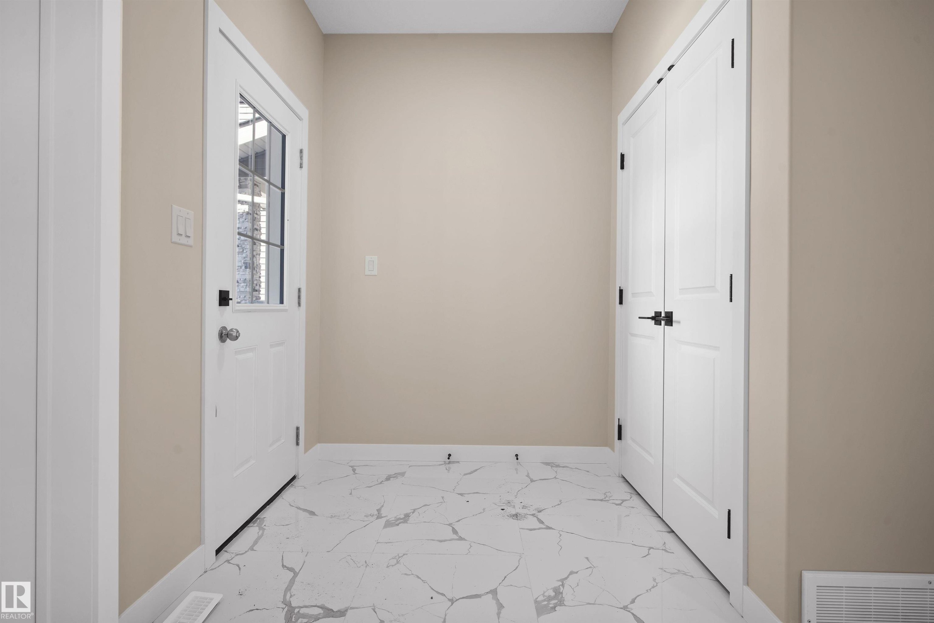 Corridor featuring light marble finish floors and baseboards - 3910 41 Avenue, Beaumont, AB - Indoor Photo Showing Other Room