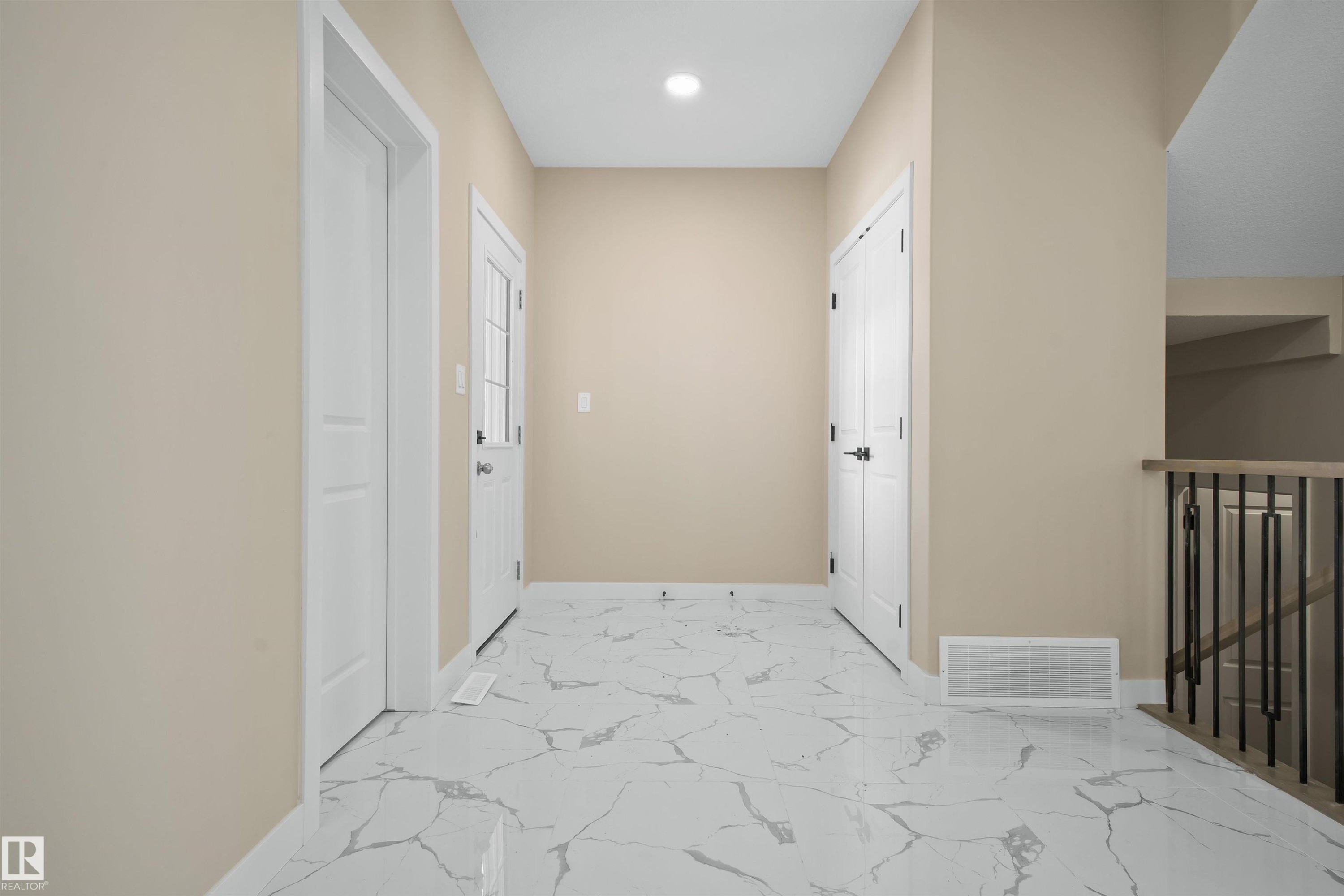 Hall featuring light marble finish flooring, an upstairs landing, and recessed lighting - 3910 41 Avenue, Beaumont, AB - Indoor Photo Showing Other Room
