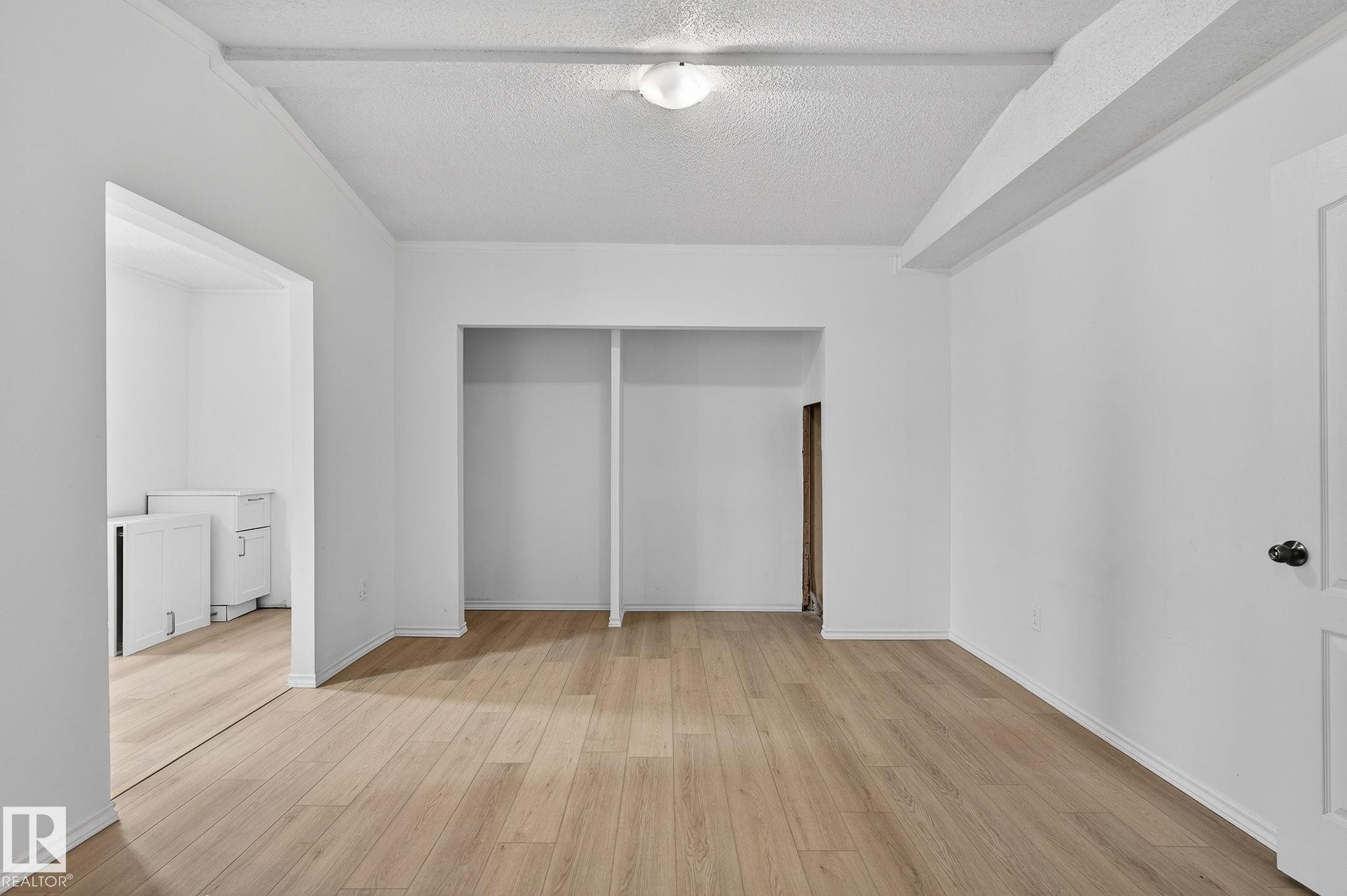Unfurnished bedroom with a closet, a textured ceiling, and light wood finished floors - 72 Evergreen Park, Edmonton, AB - Indoor Photo Showing Other Room