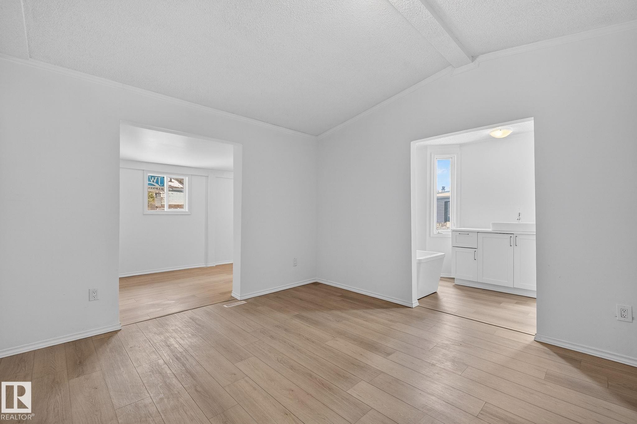 Unfurnished room with crown molding, beamed ceiling, and light wood finished floors - 72 Evergreen Park, Edmonton, AB - Indoor Photo Showing Other Room