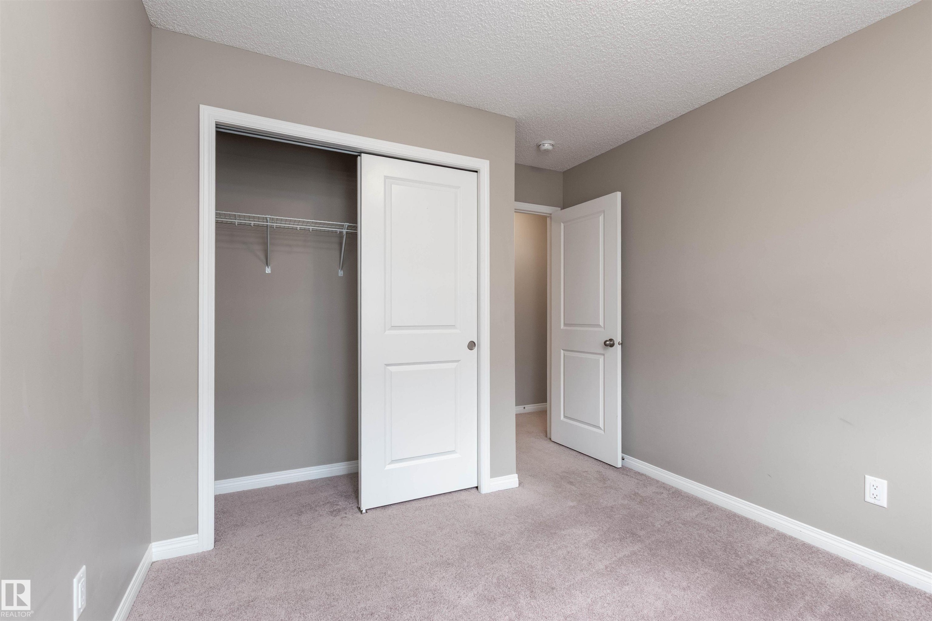 view of bedroom 3 - 105 2072 Wonnacott Way, Edmonton, AB - Indoor Photo Showing Other Room