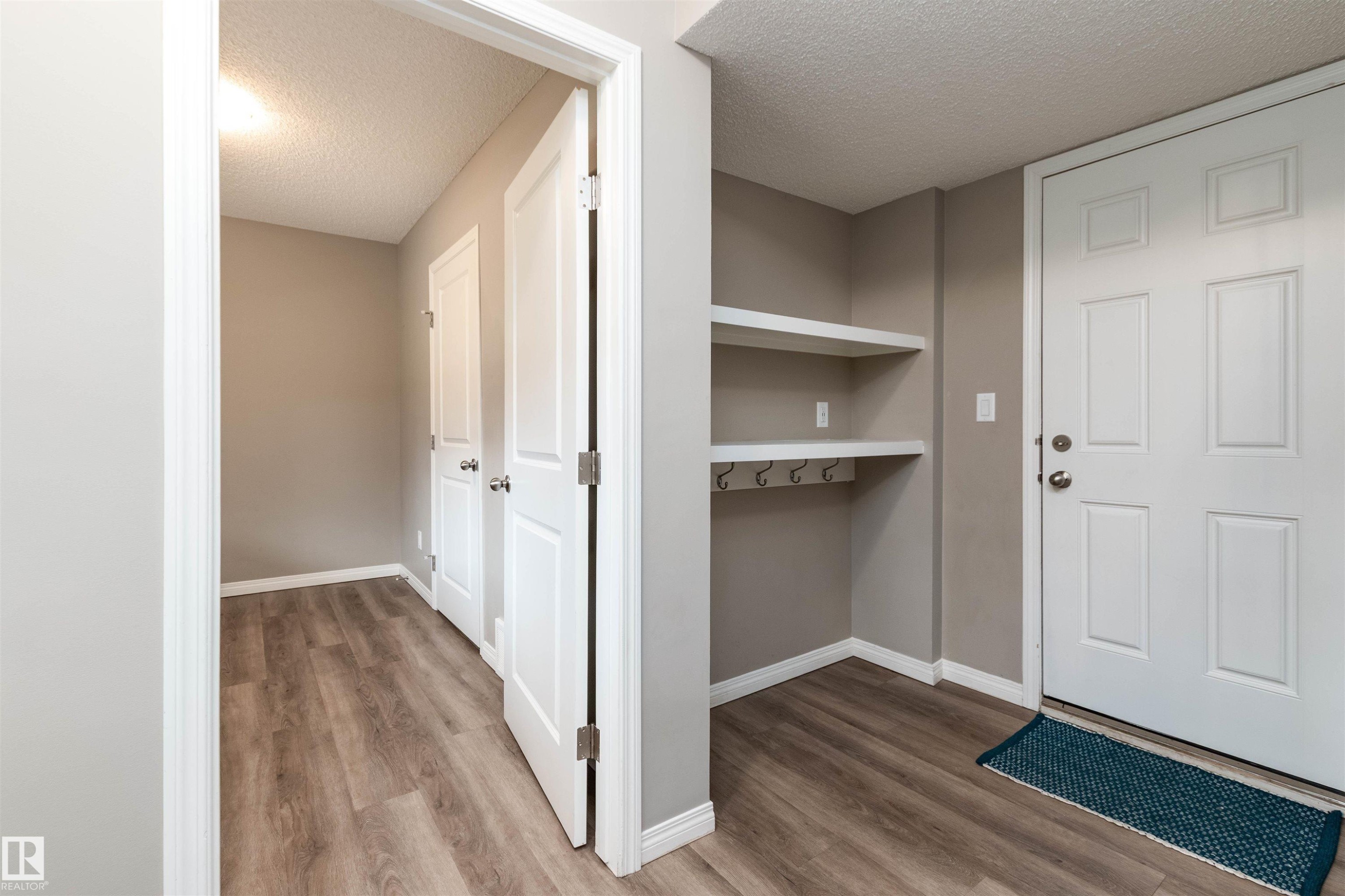 Hallway featuring a textured ceiling - 105 2072 Wonnacott Way, Edmonton, AB - Indoor Photo Showing Other Room