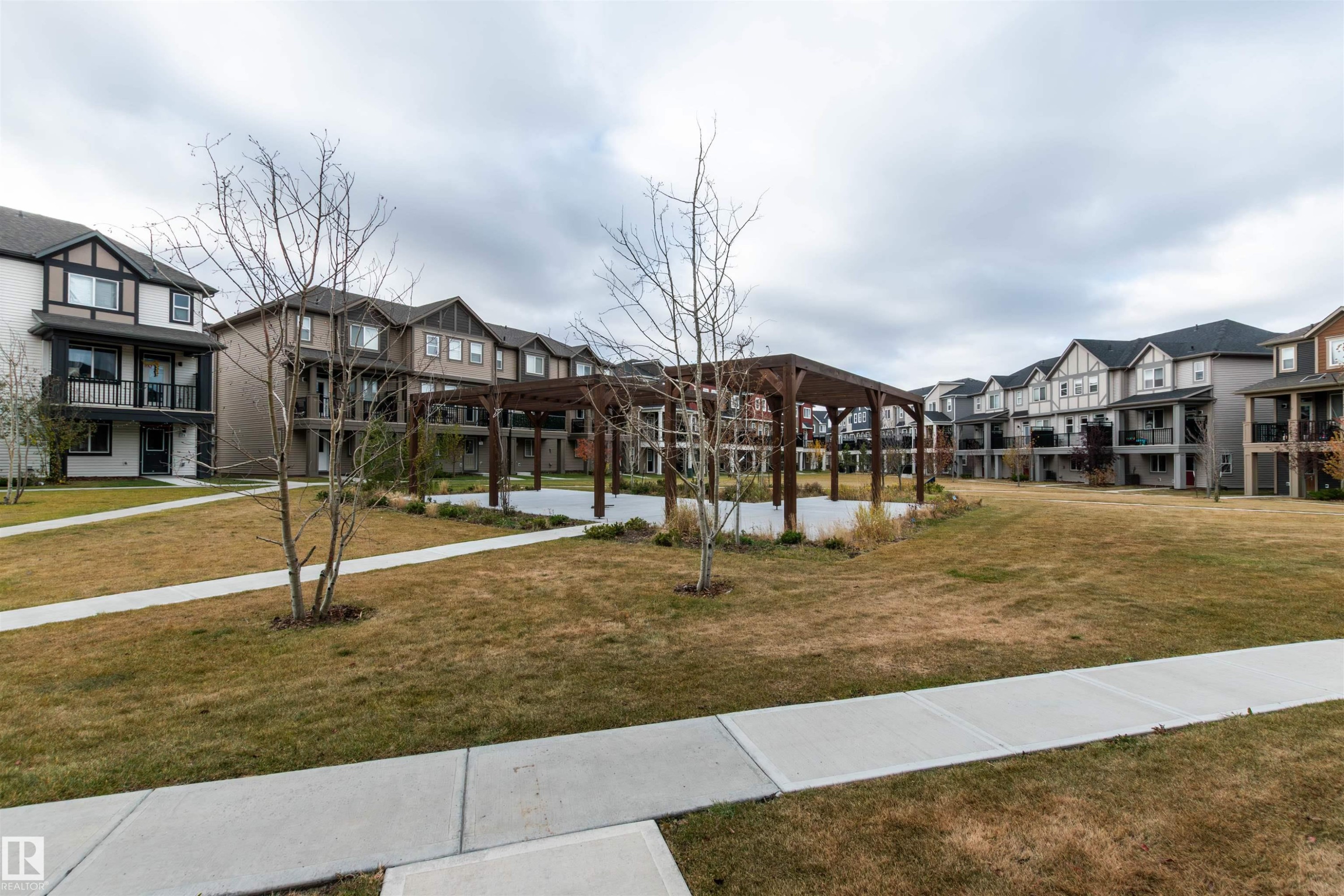 Surrounding community with a residential view and a lawn - 105 2072 Wonnacott Way, Edmonton, AB - Outdoor With Facade
