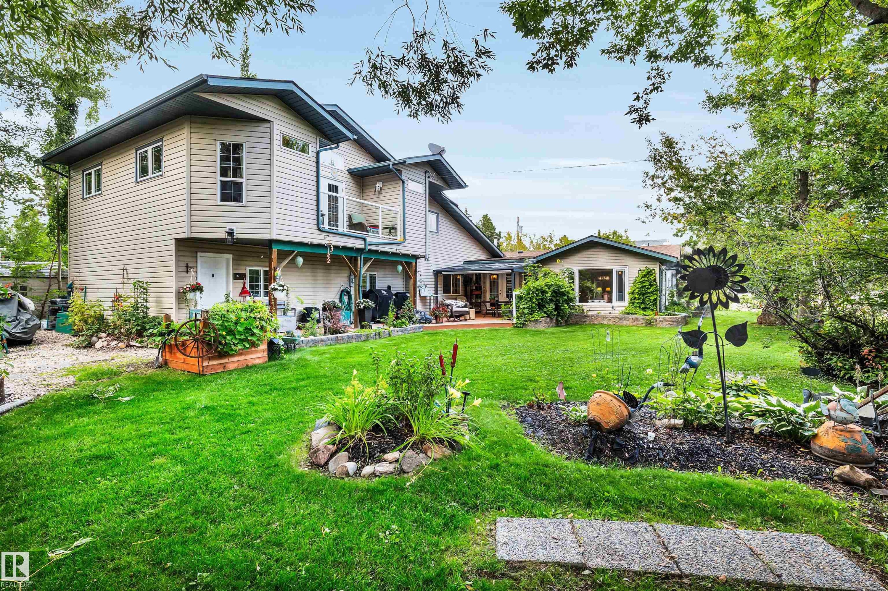 Back of house with a lawn and a deck - 605 6St. Ross Haven, Rural Lac Ste. Anne County, AB - Outdoor