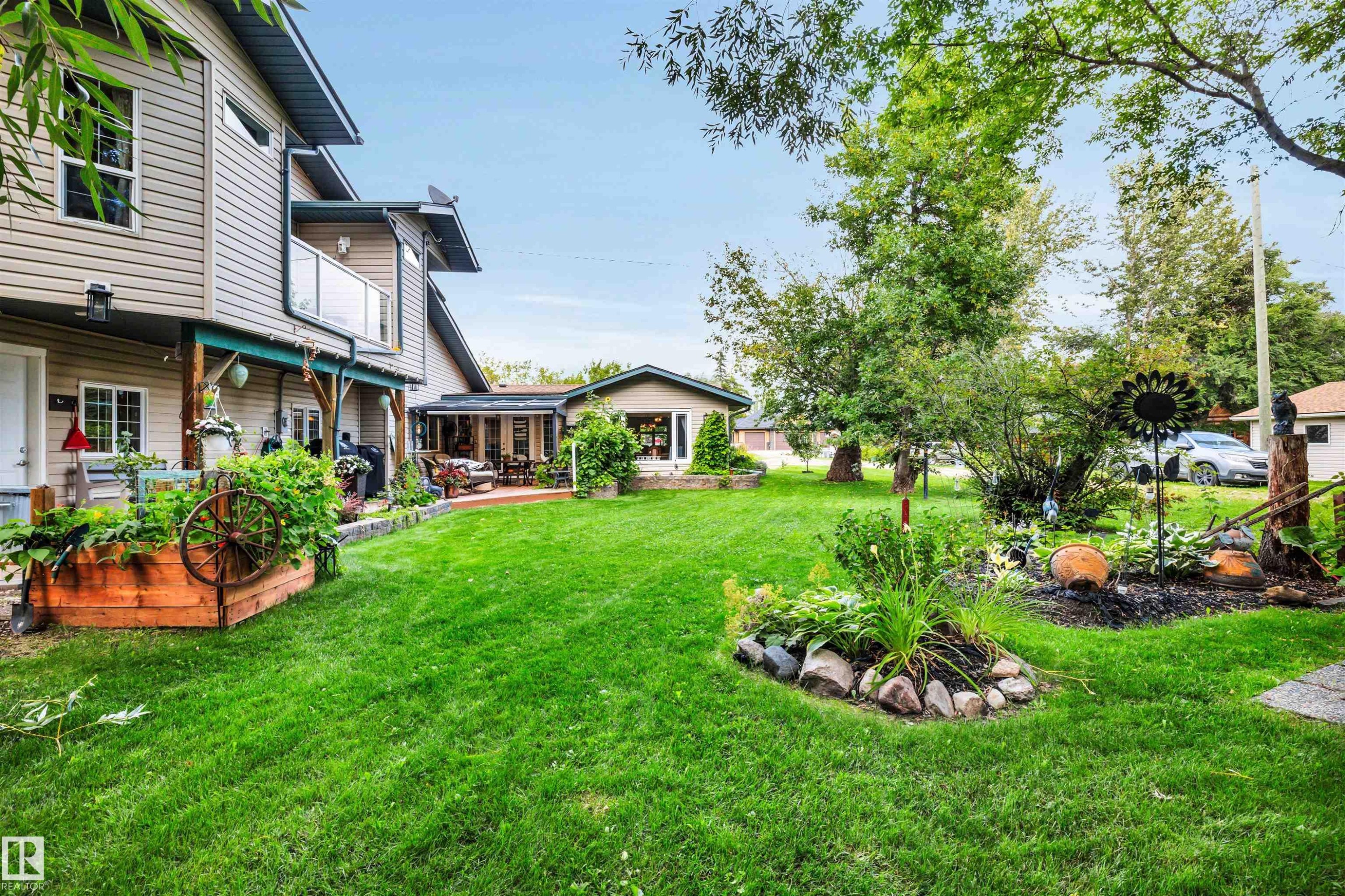 View of grassy yard featuring a balcony - 605 6St. Ross Haven, Rural Lac Ste. Anne County, AB - Outdoor With Deck Patio Veranda