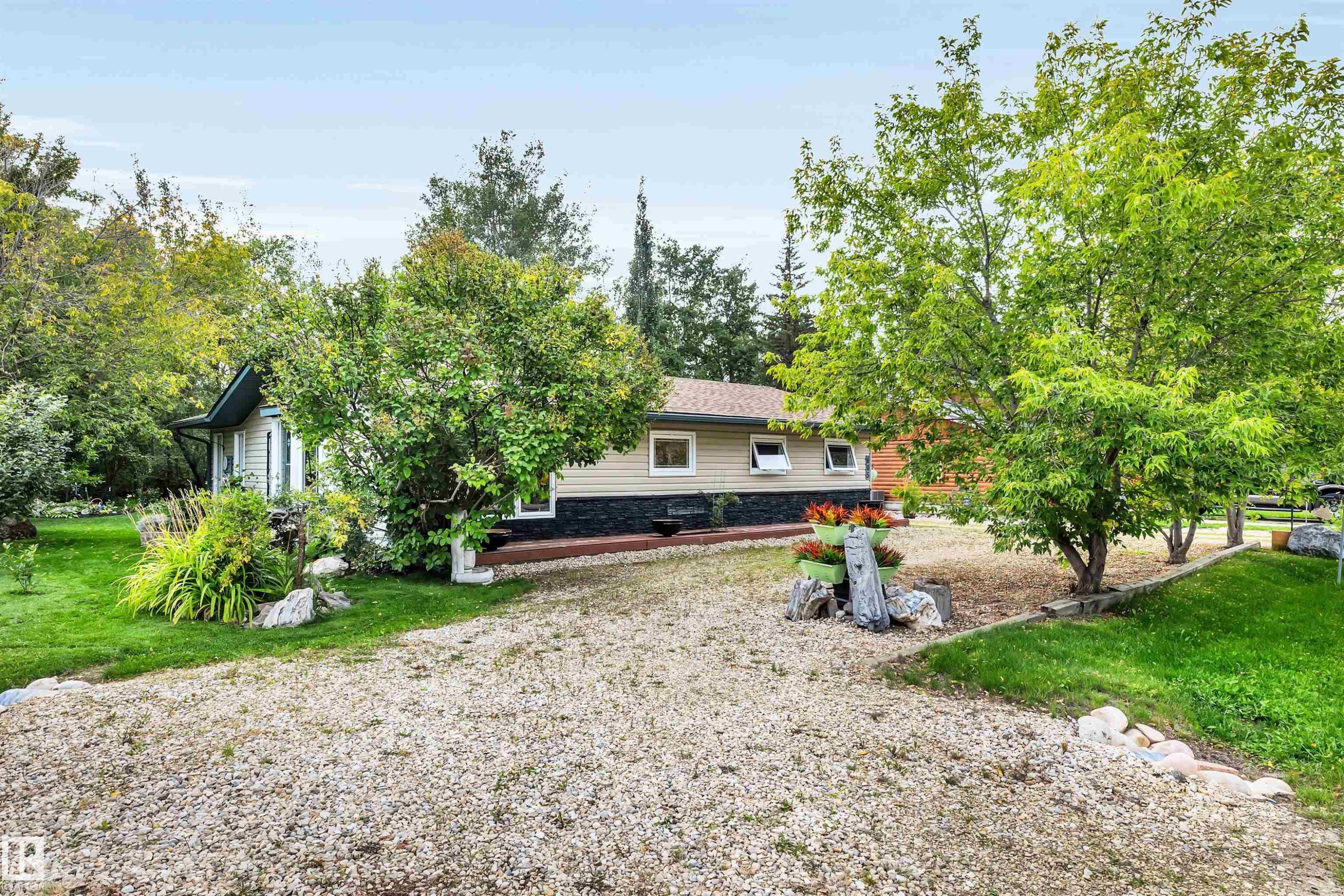 Rear view of property featuring a lawn - 605 6St. Ross Haven, Rural Lac Ste. Anne County, AB - Outdoor