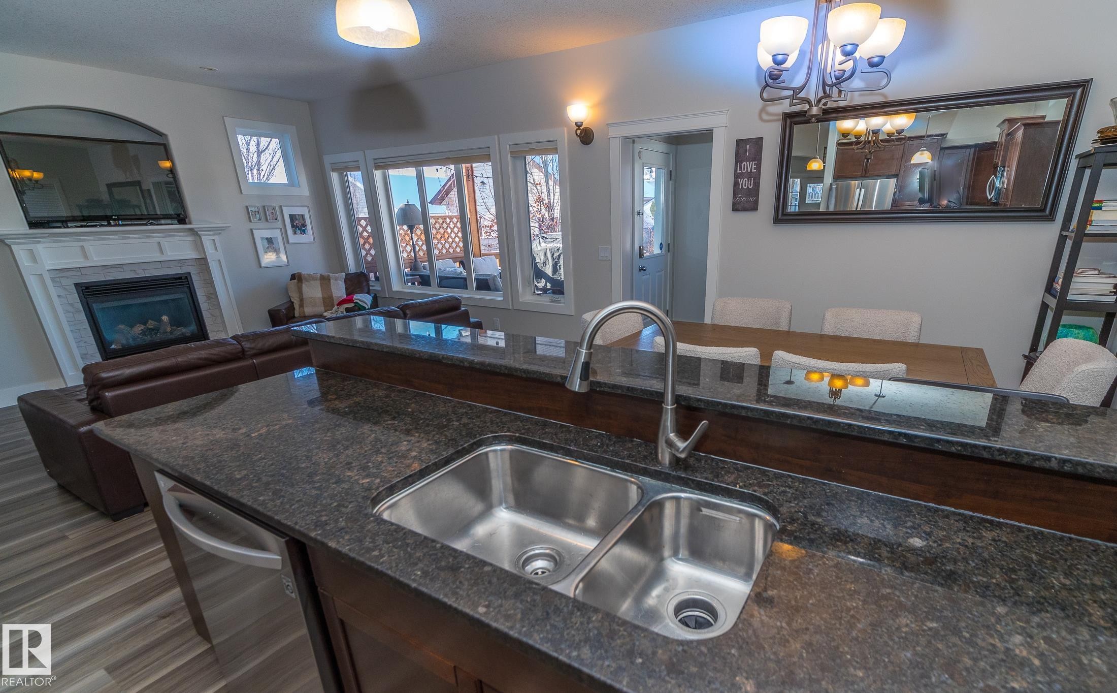 6152 Stinson Way, Edmonton, AB - Indoor Photo Showing Kitchen With Fireplace With Double Sink