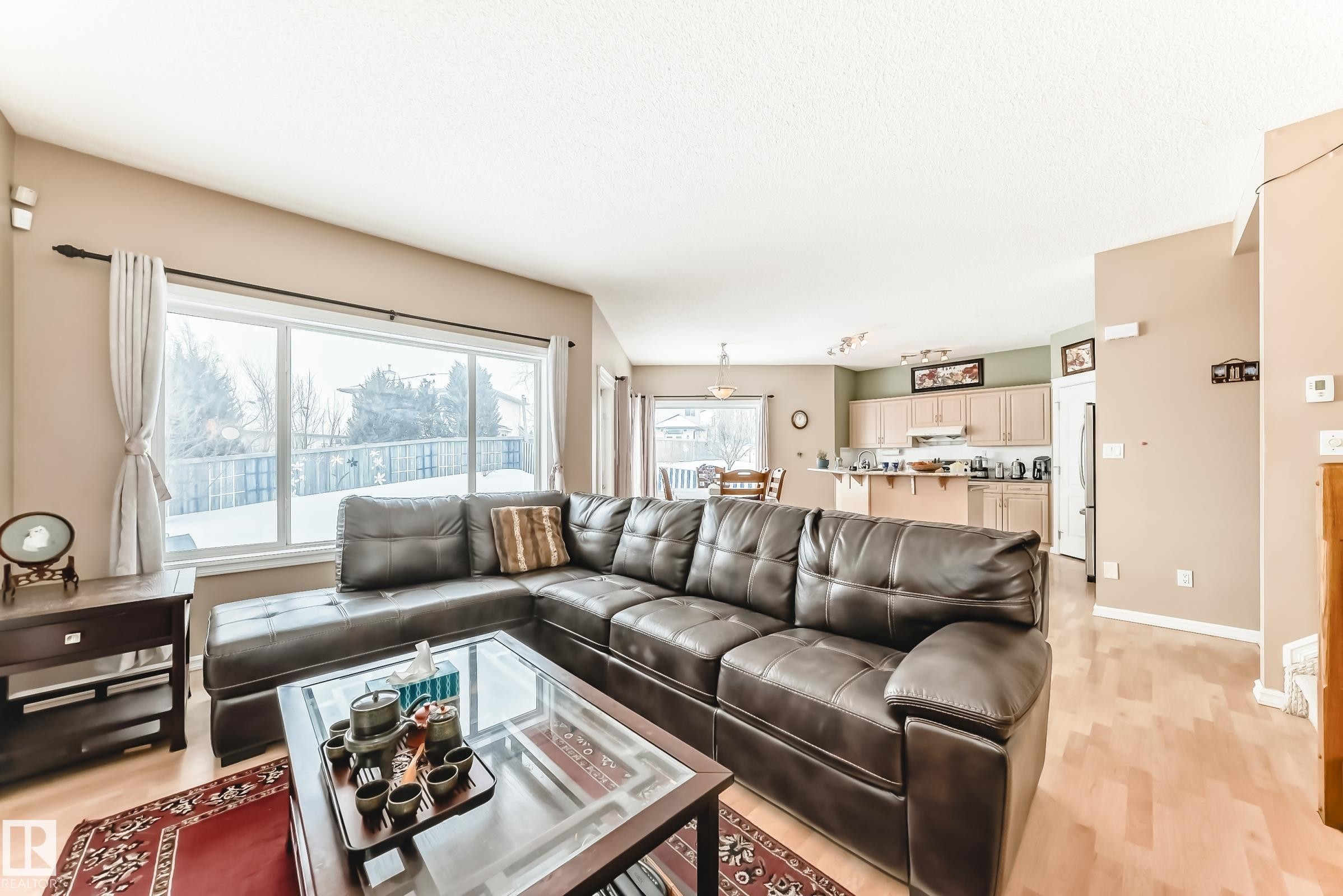 Living area featuring light wood-type flooring and baseboards - 4619 151 Avenue, Edmonton, AB - Indoor Photo Showing Living Room