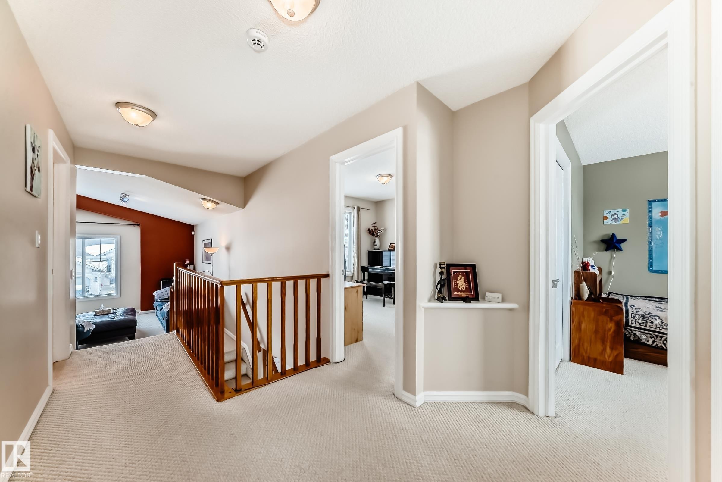 Hall with an upstairs landing, light colored carpet, and lofted ceiling - 4619 151 Avenue, Edmonton, AB - Indoor Photo Showing Other Room