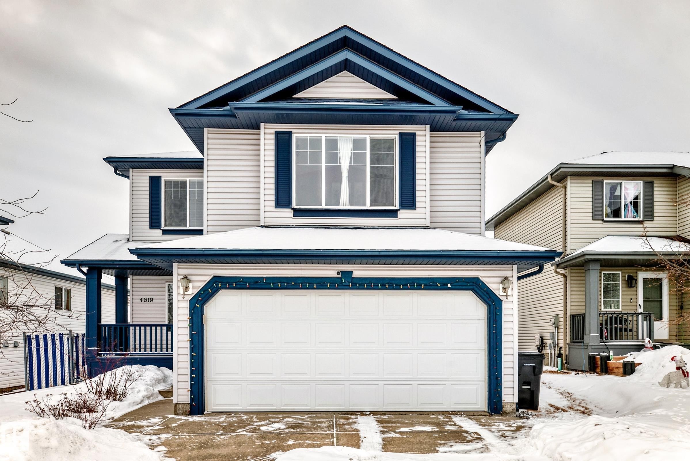 View of front facade with a garage and covered porch - 4619 151 Avenue, Edmonton, AB - Outdoor With Facade