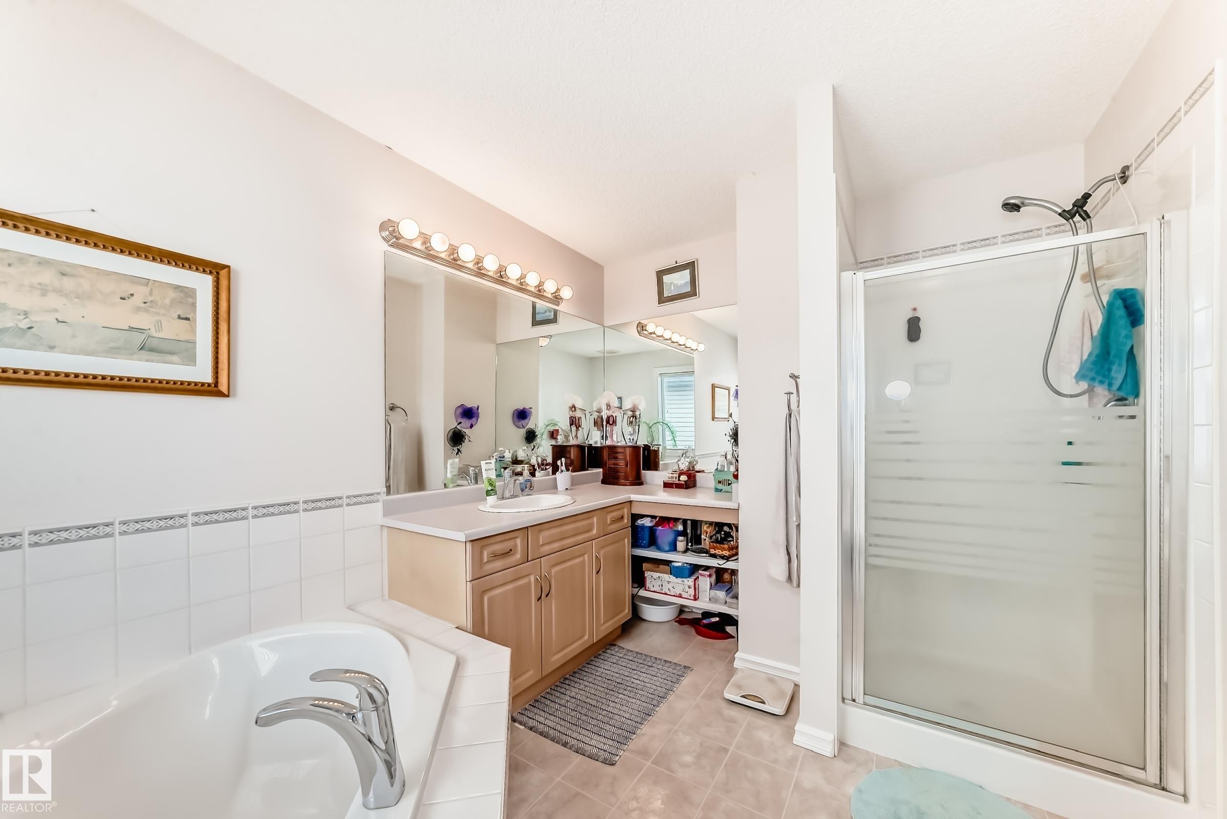 Full bath with vanity, a shower stall, a bath, and light tile patterned floors - 4619 151 Avenue, Edmonton, AB - Indoor Photo Showing Bathroom