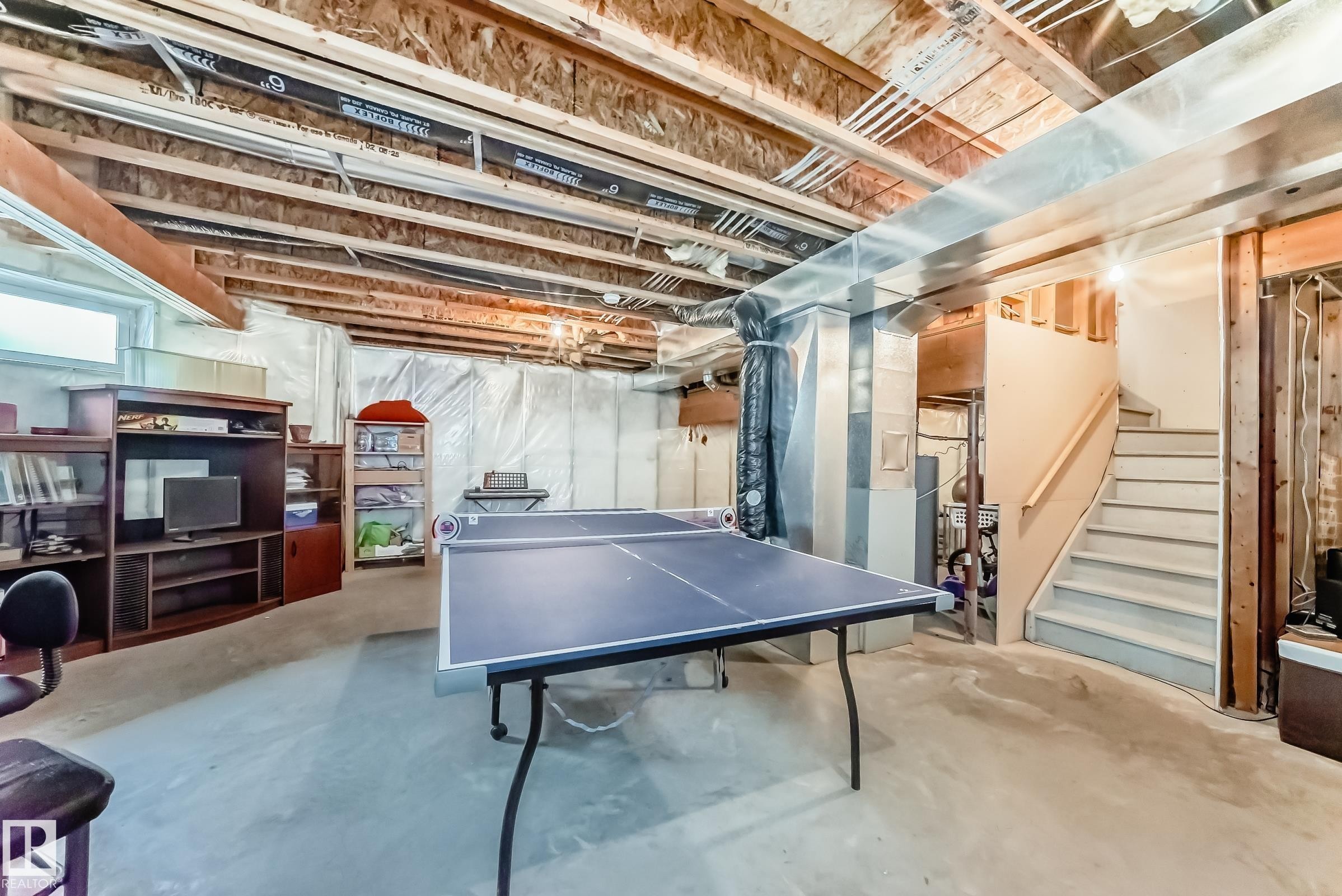 Rec room with concrete flooring and heating unit - 4619 151 Avenue, Edmonton, AB - Indoor Photo Showing Basement