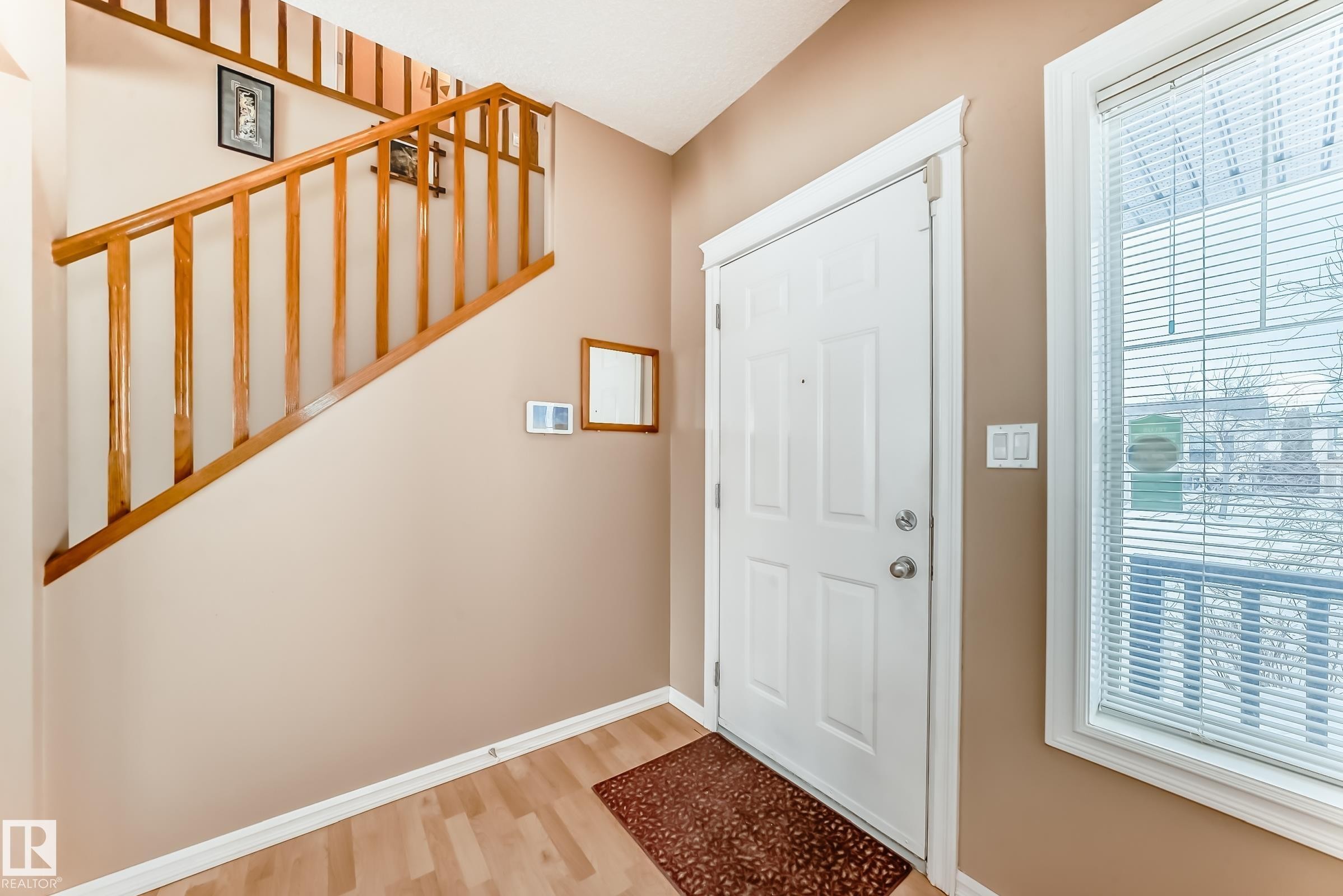 Foyer with light wood-style flooring and baseboards - 4619 151 Avenue, Edmonton, AB - Indoor Photo Showing Other Room