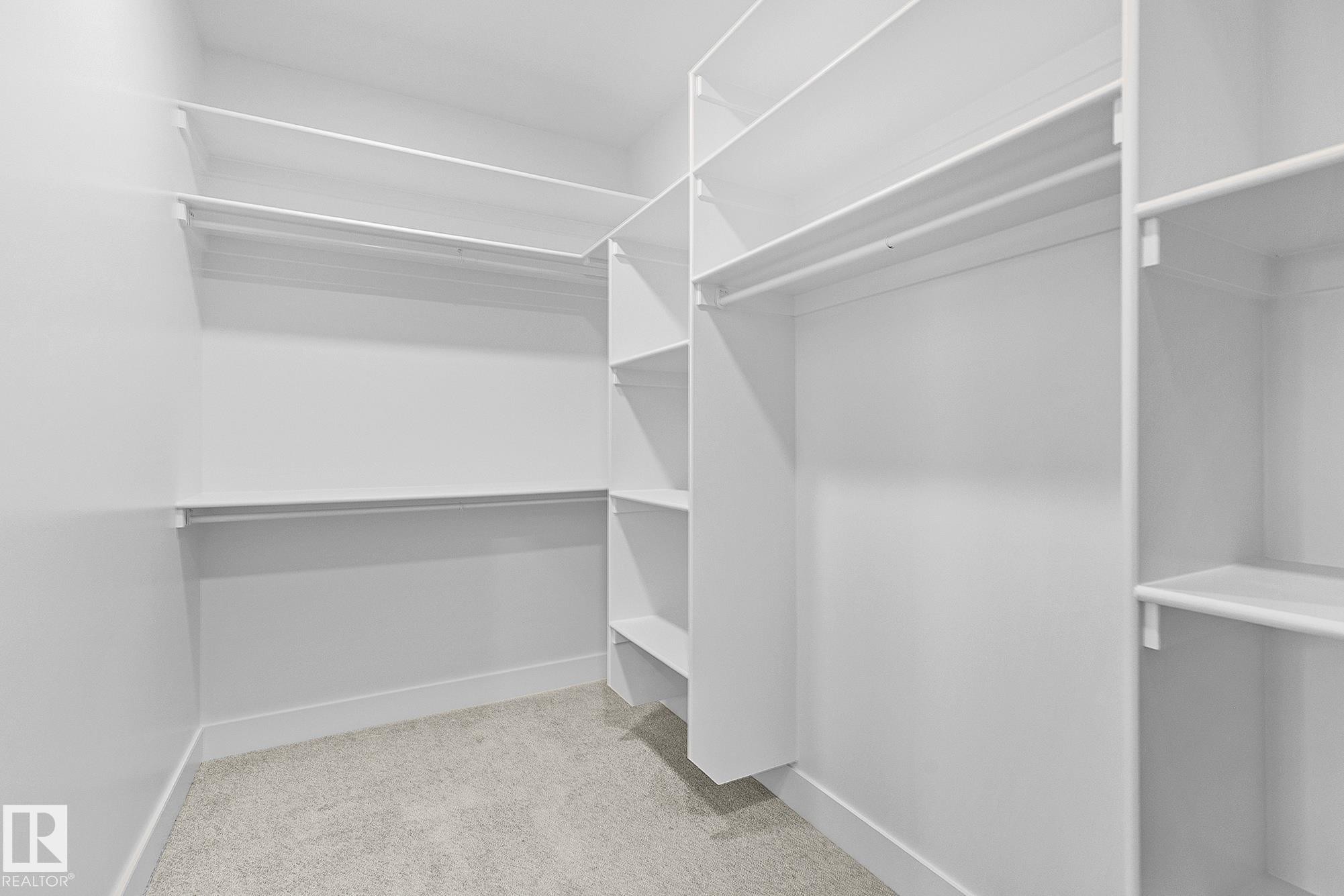 Walk in closet with light colored carpet - 523 Ashgrove Circle, Leduc, AB - Indoor With Storage