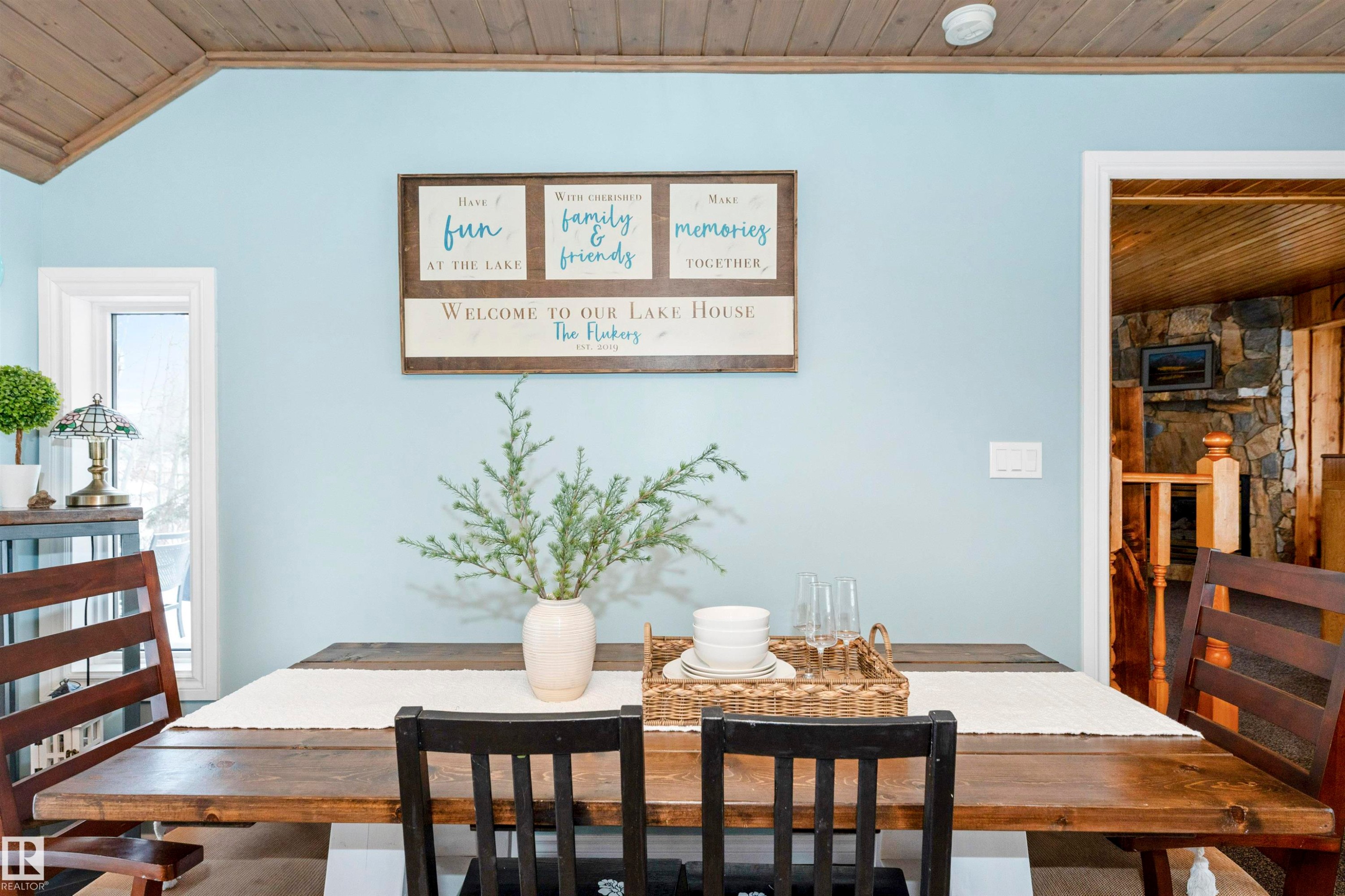 Kitchen with white cabinets, a breakfast bar, wooden counters, decorative light fixtures, and stainless steel appliances - 516 5 Street, Rural Lac Ste. Anne County, AB - Indoor