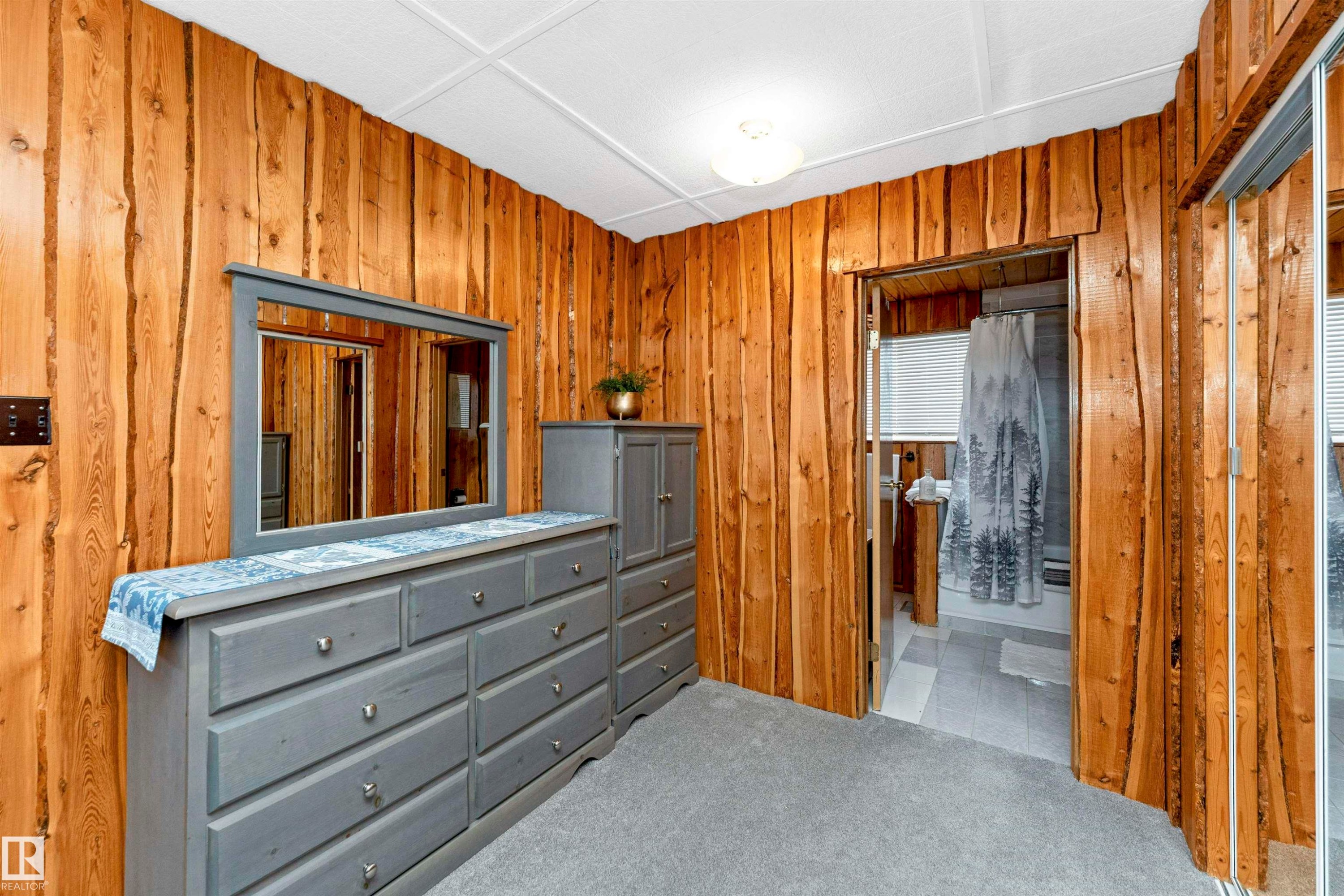 Bedroom with carpet floors and wooden walls - 516 5 Street, Rural Lac Ste. Anne County, AB - Indoor Photo Showing Bedroom