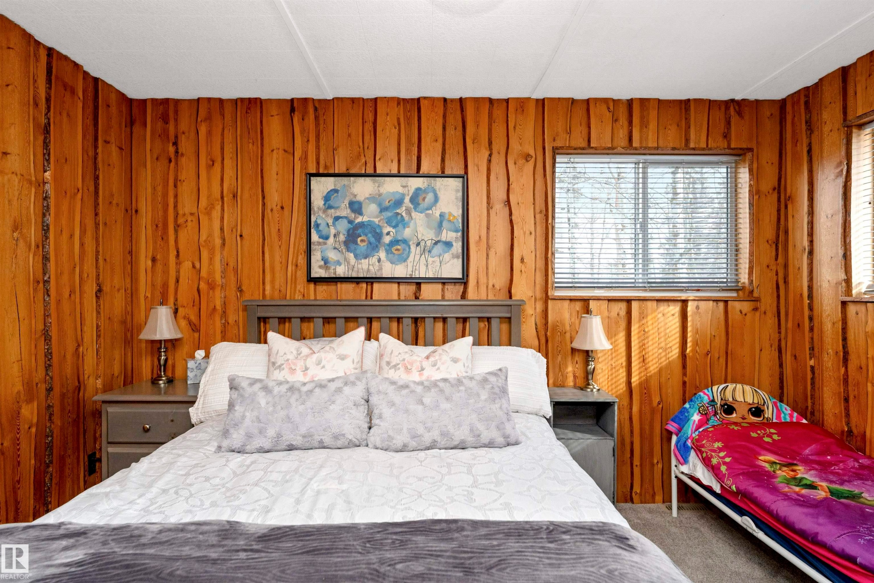 Bedroom with light carpet and wooden walls - 516 5 Street, Rural Lac Ste. Anne County, AB - Indoor Photo Showing Bedroom