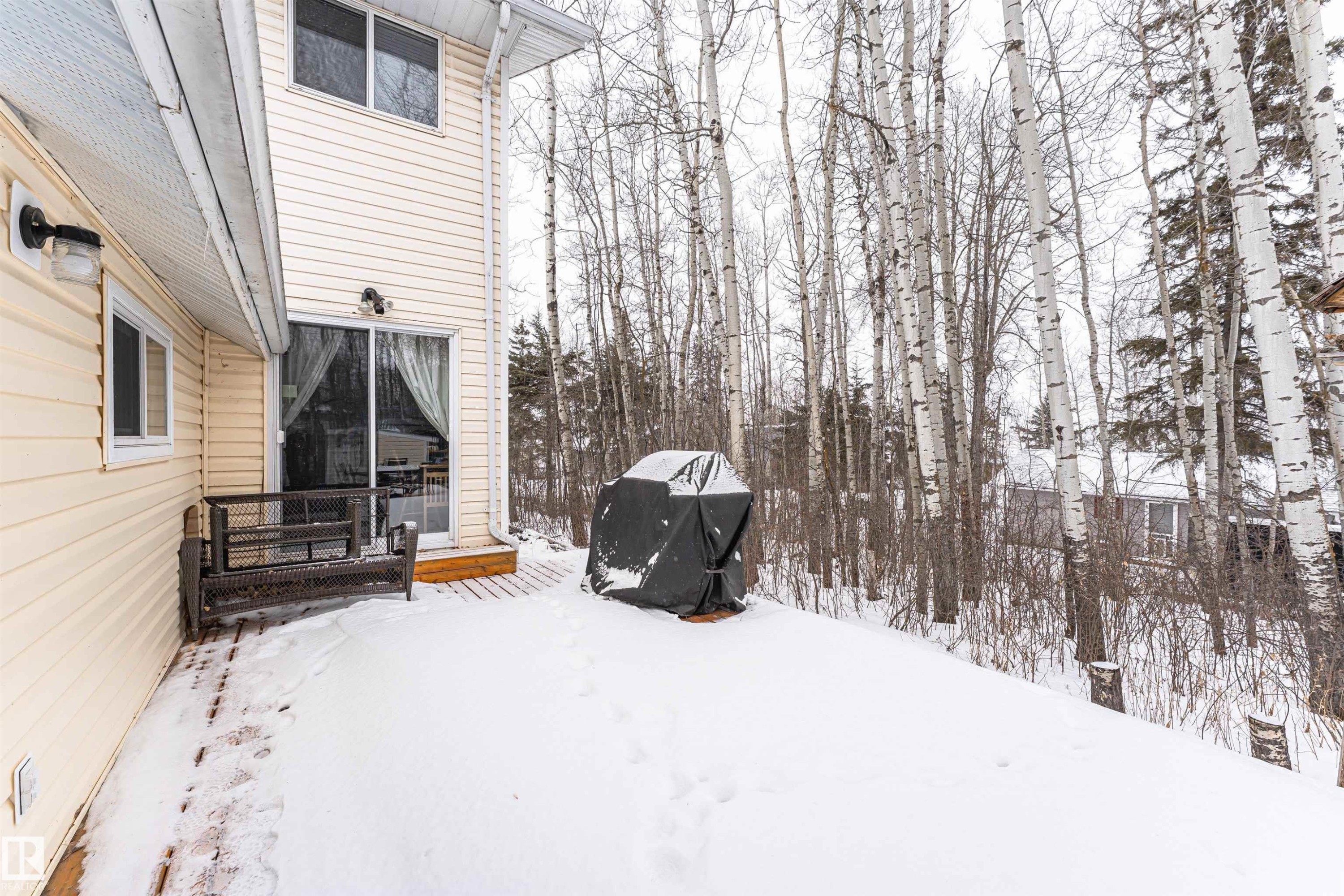 Snowy yard featuring a wooden deck - 516 5 Street, Rural Lac Ste. Anne County, AB - Outdoor