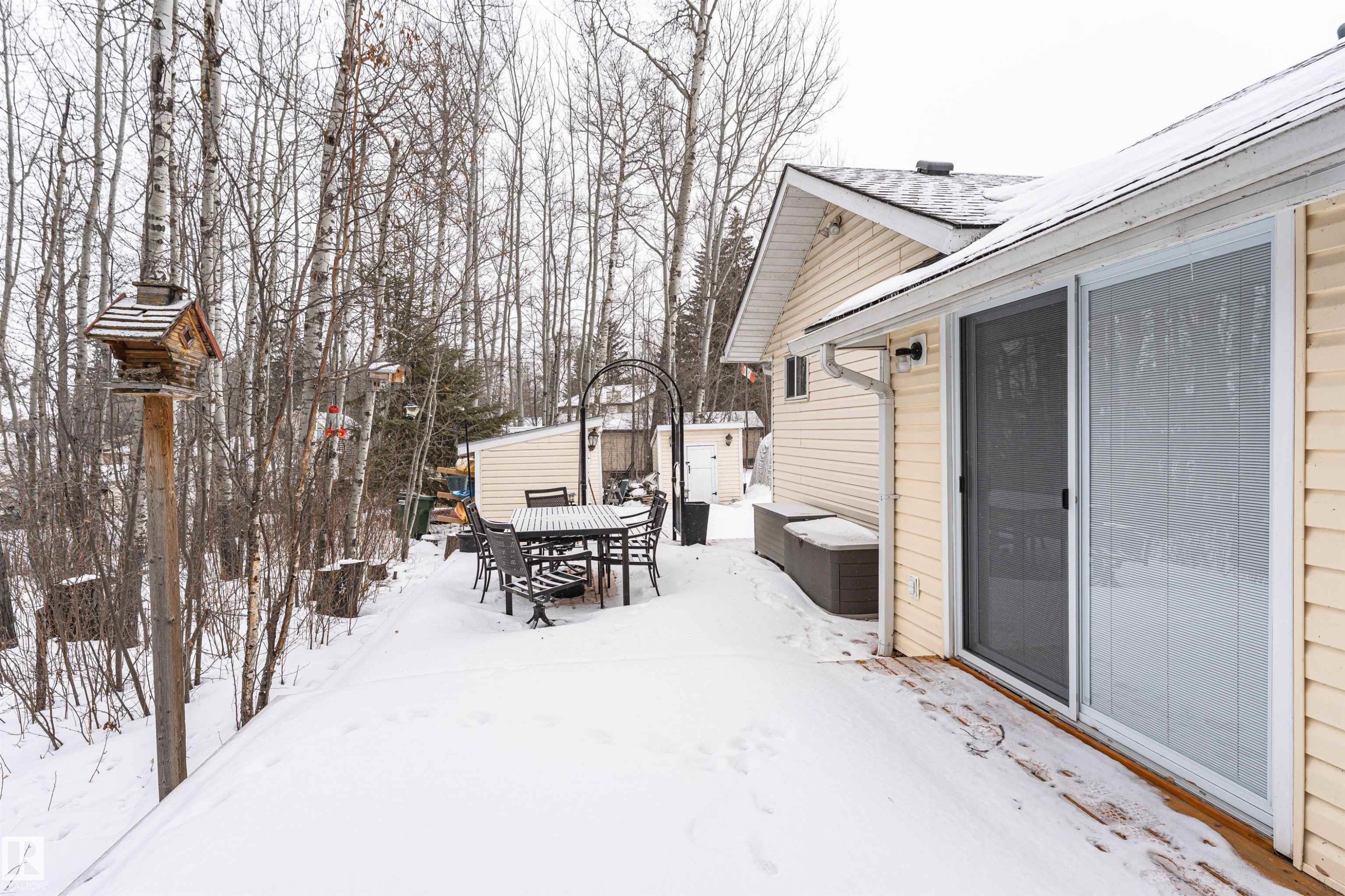 Snow covered patio with outdoor dining space and a patio area - 516 5 Street, Rural Lac Ste. Anne County, AB - Outdoor