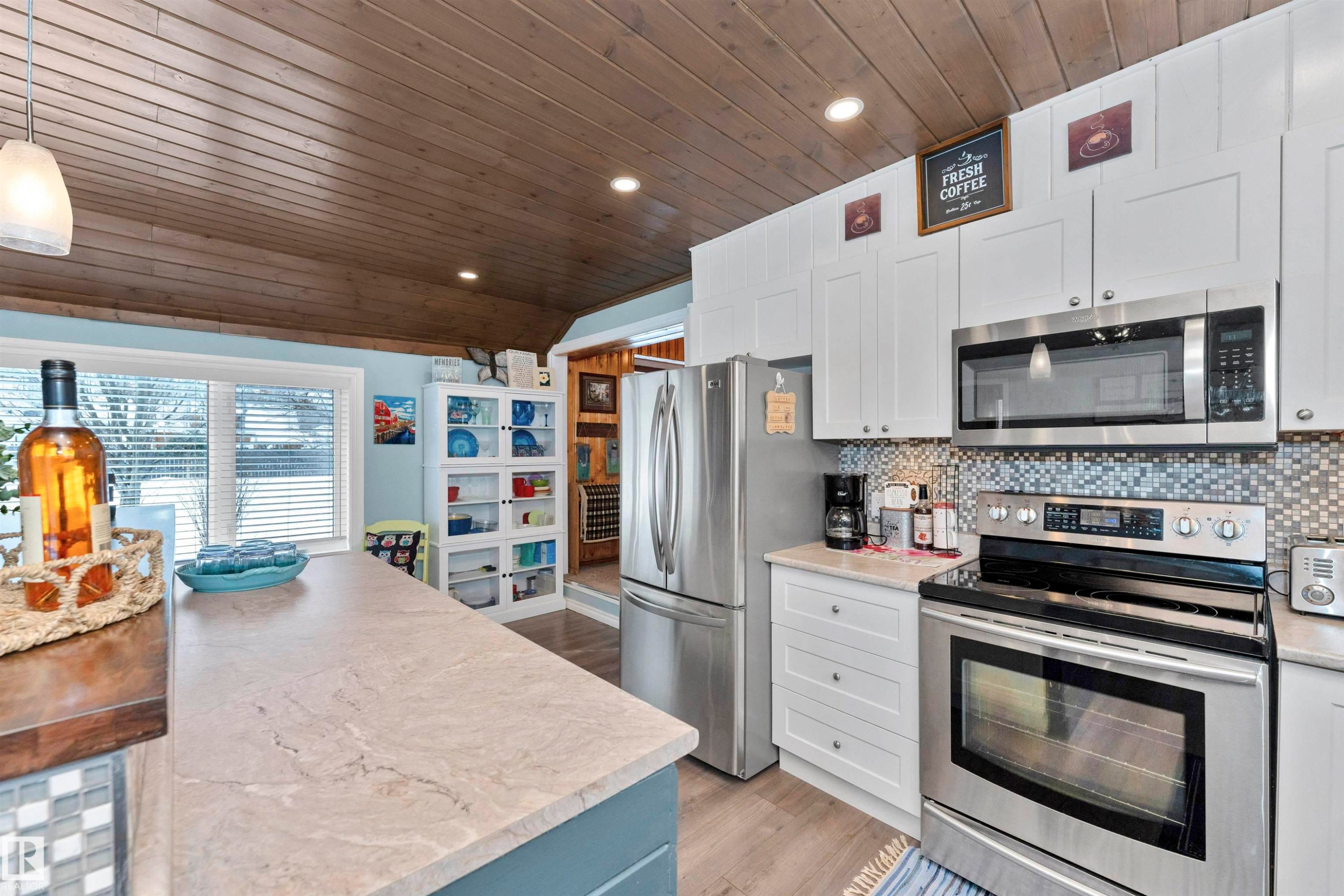 Kitchen with wood counters, stainless steel appliances, decorative light fixtures, dark wood-type flooring, and tasteful backsplash - 516 5 Street, Rural Lac Ste. Anne County, AB - Indoor Photo Showing Kitchen With Upgraded Kitchen