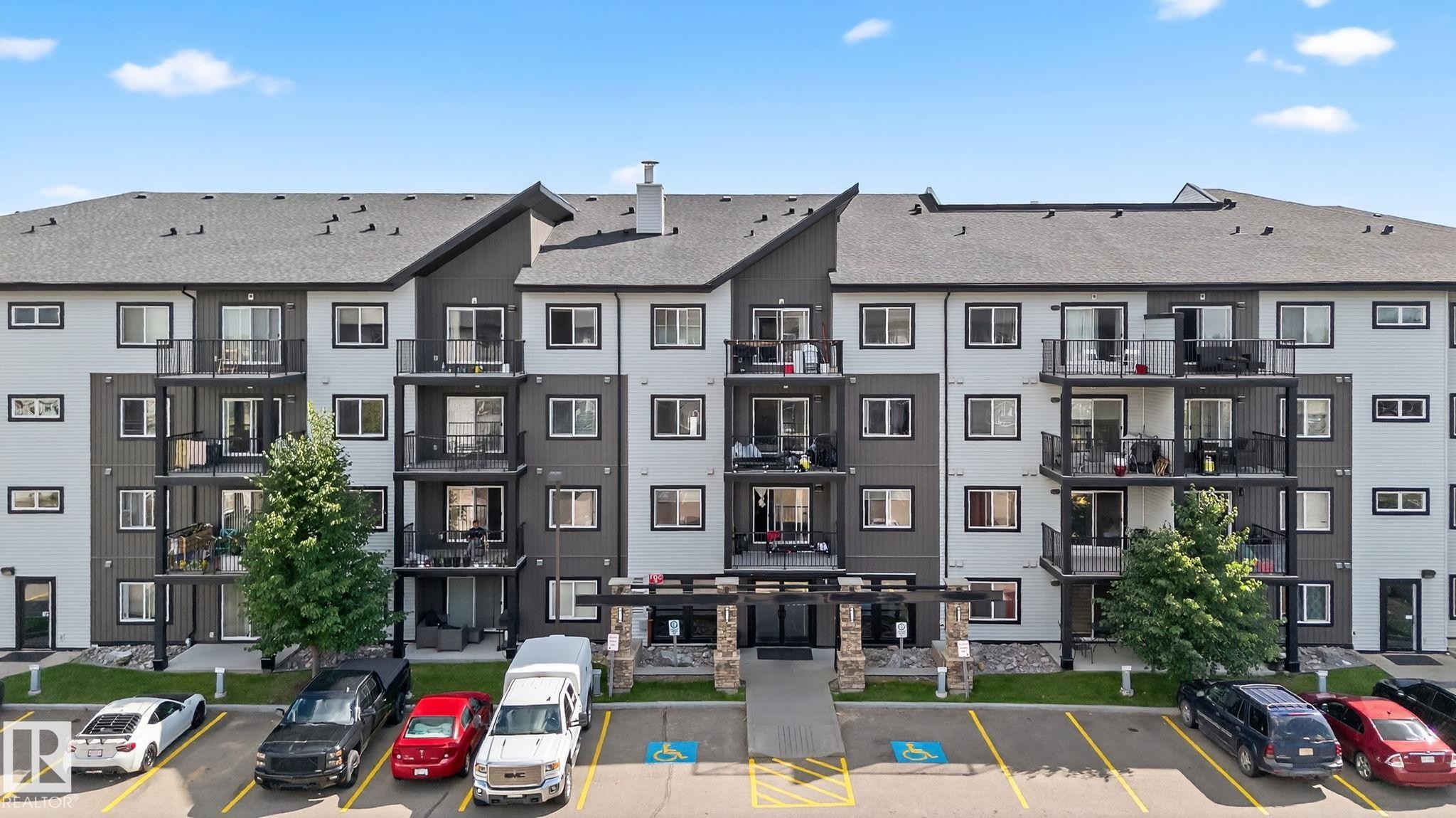View of apartment building / complex with uncovered parking - 209 3353 16A, Edmonton, AB - Outdoor With Facade