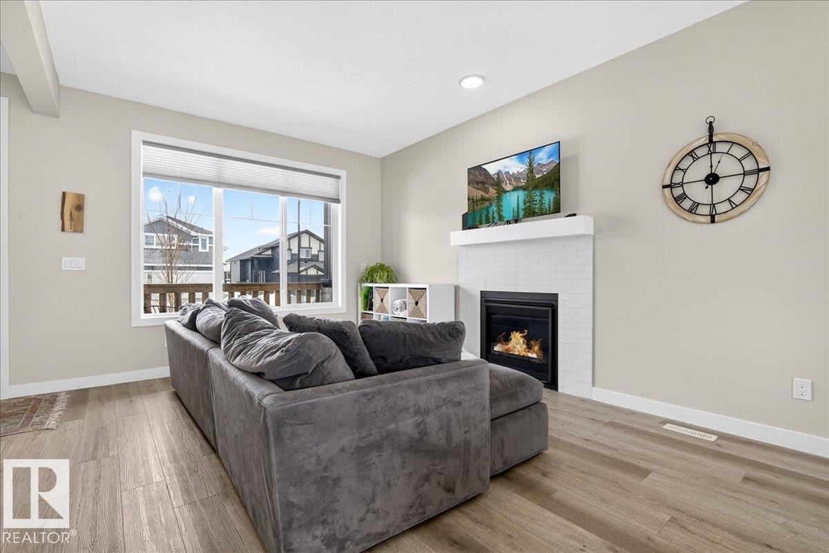 80 Maple Crescent, Gibbons, AB - Indoor Photo Showing Living Room With Fireplace