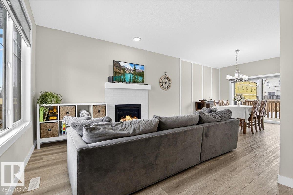 80 Maple Crescent, Gibbons, AB - Indoor Photo Showing Living Room With Fireplace